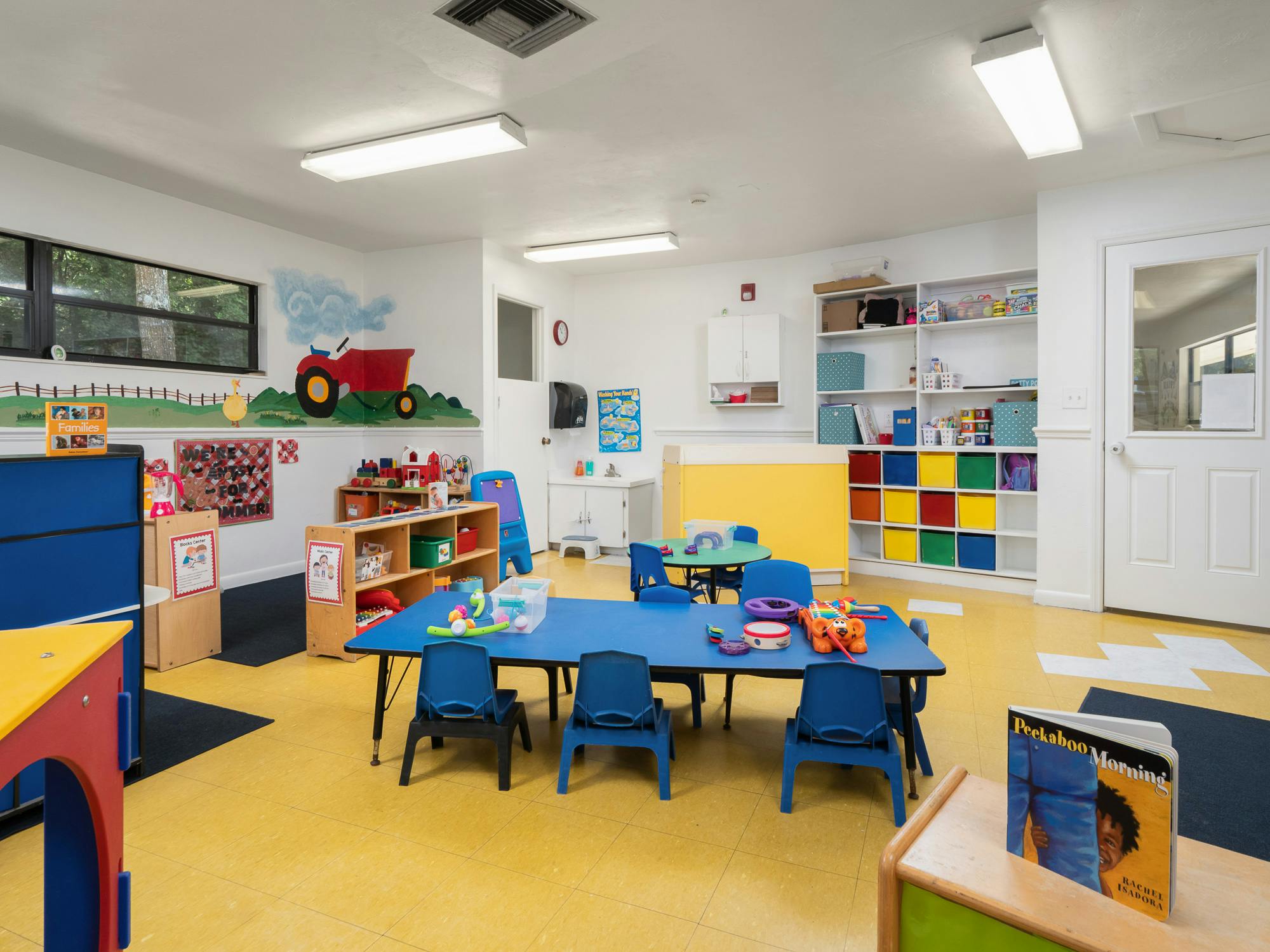 Empty classroom with small tables and chairs
