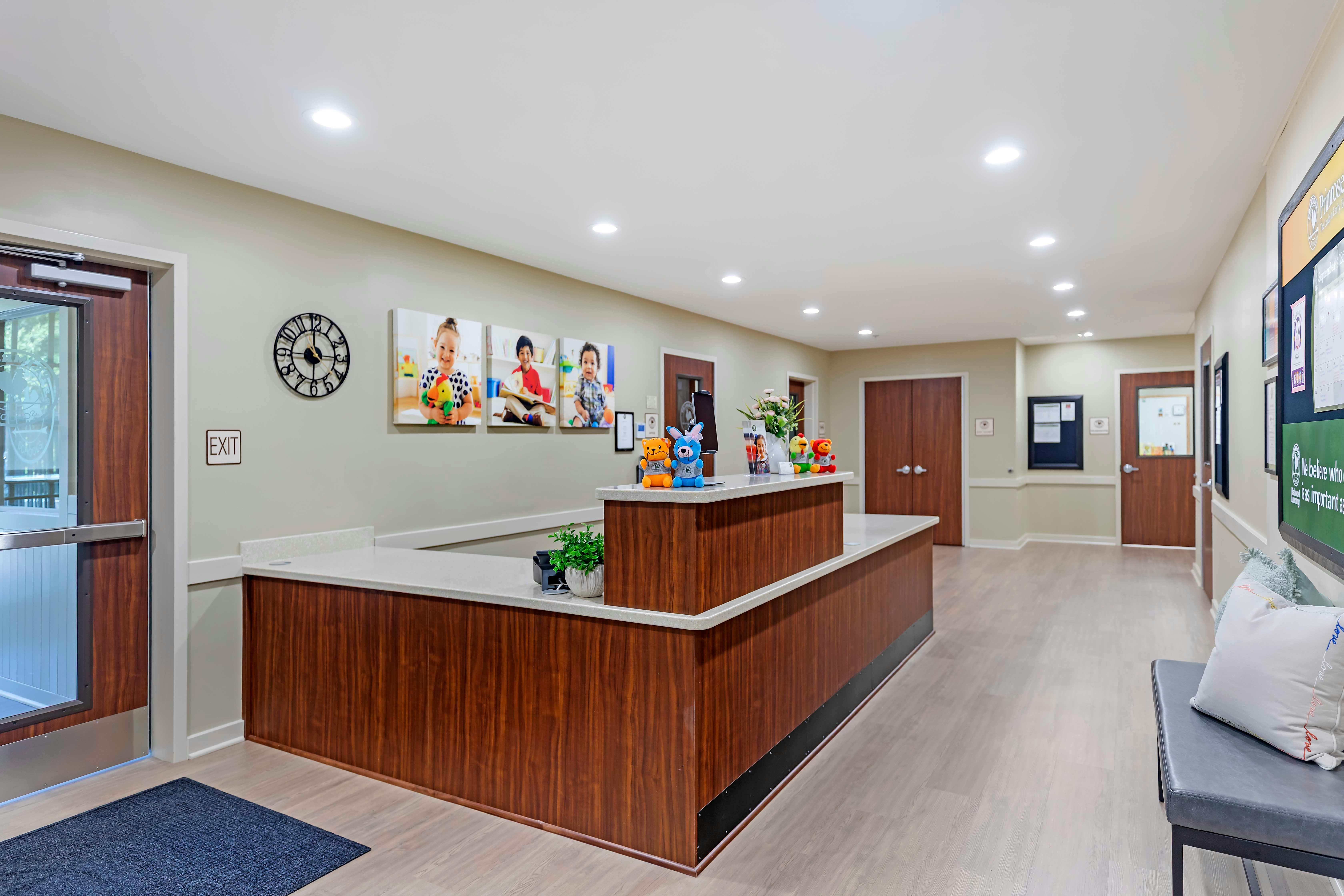 Reception desk with three photos of children playing above it
