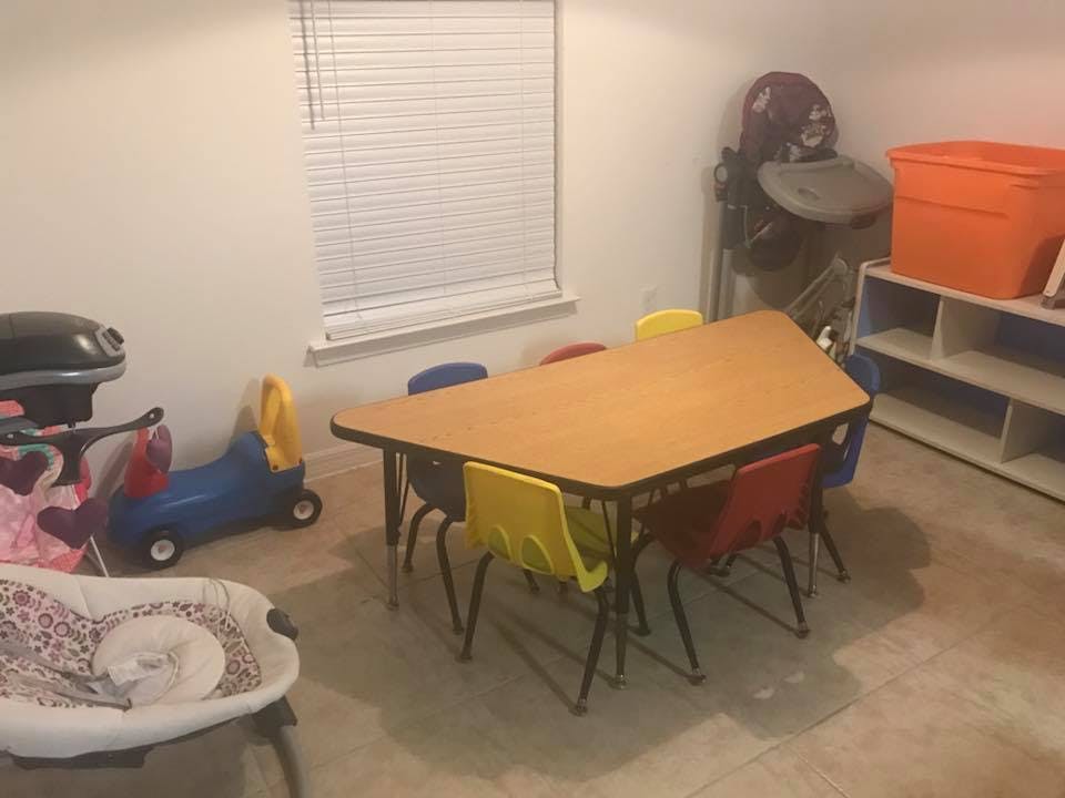 Children's table with colorful chairs in a room with toys