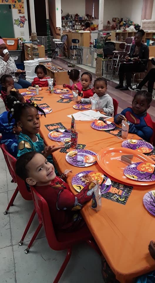 Children sitting at a table with Halloween-themed plates