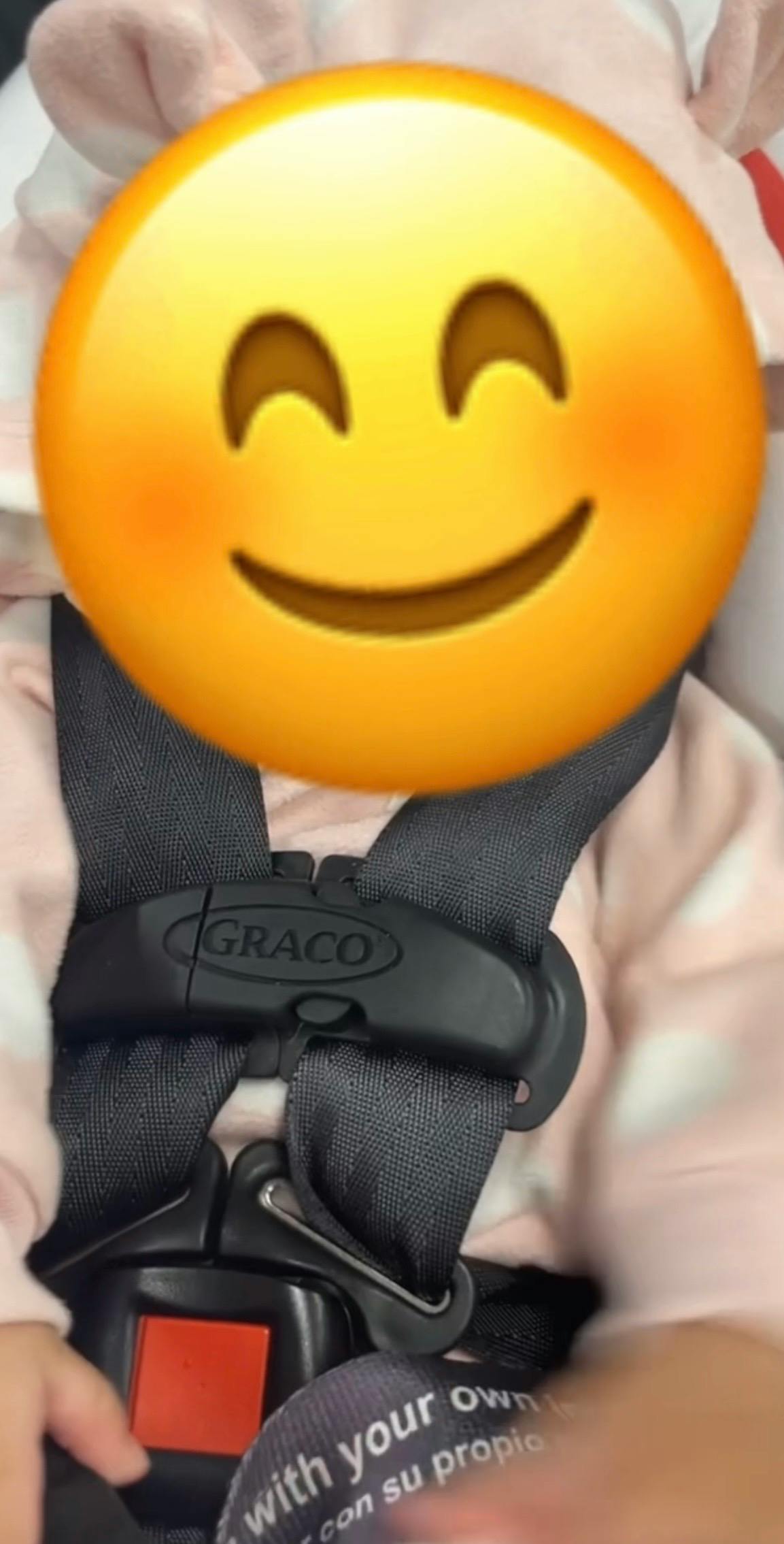 Child secured in a Graco car seat