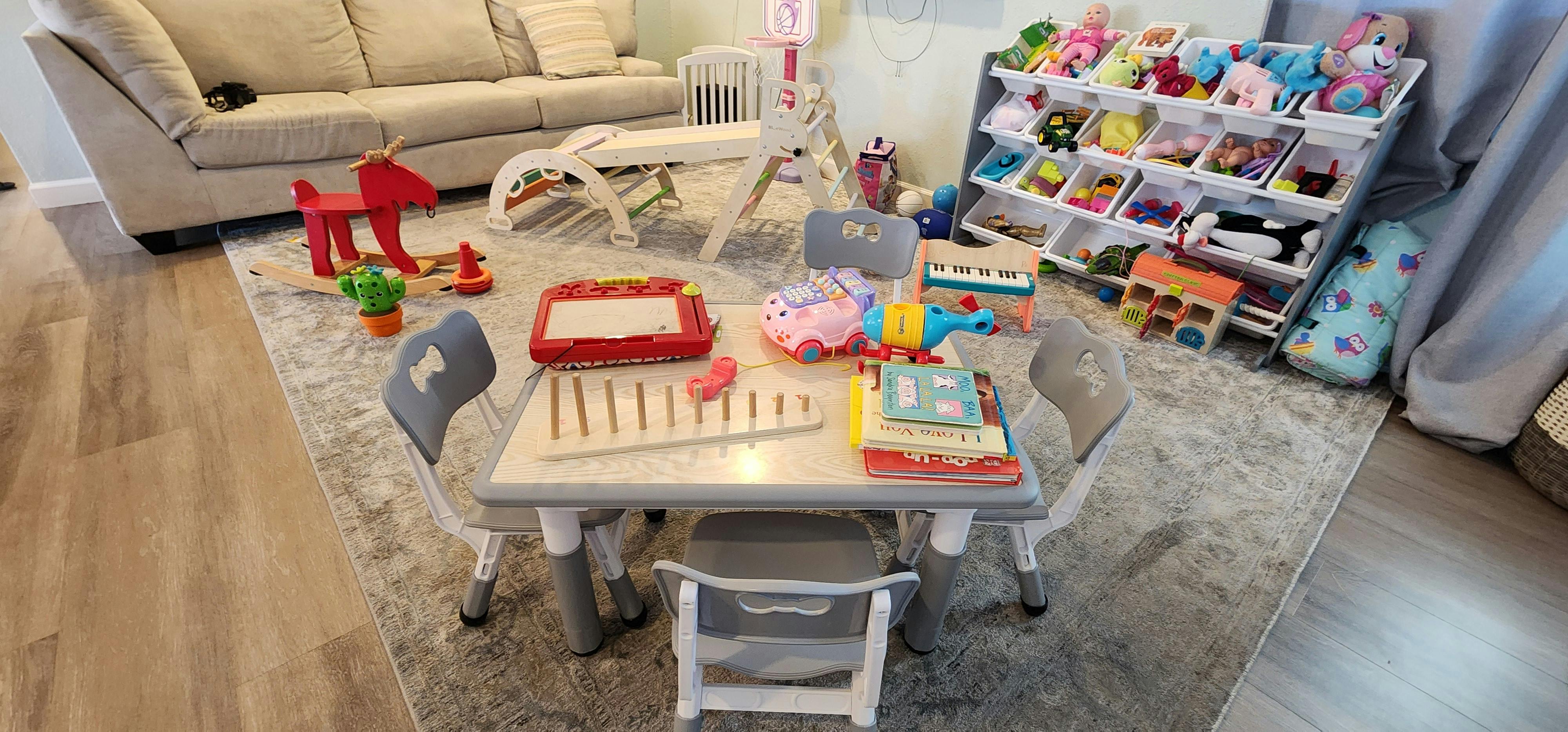 Children's play table with toys and storage shelves