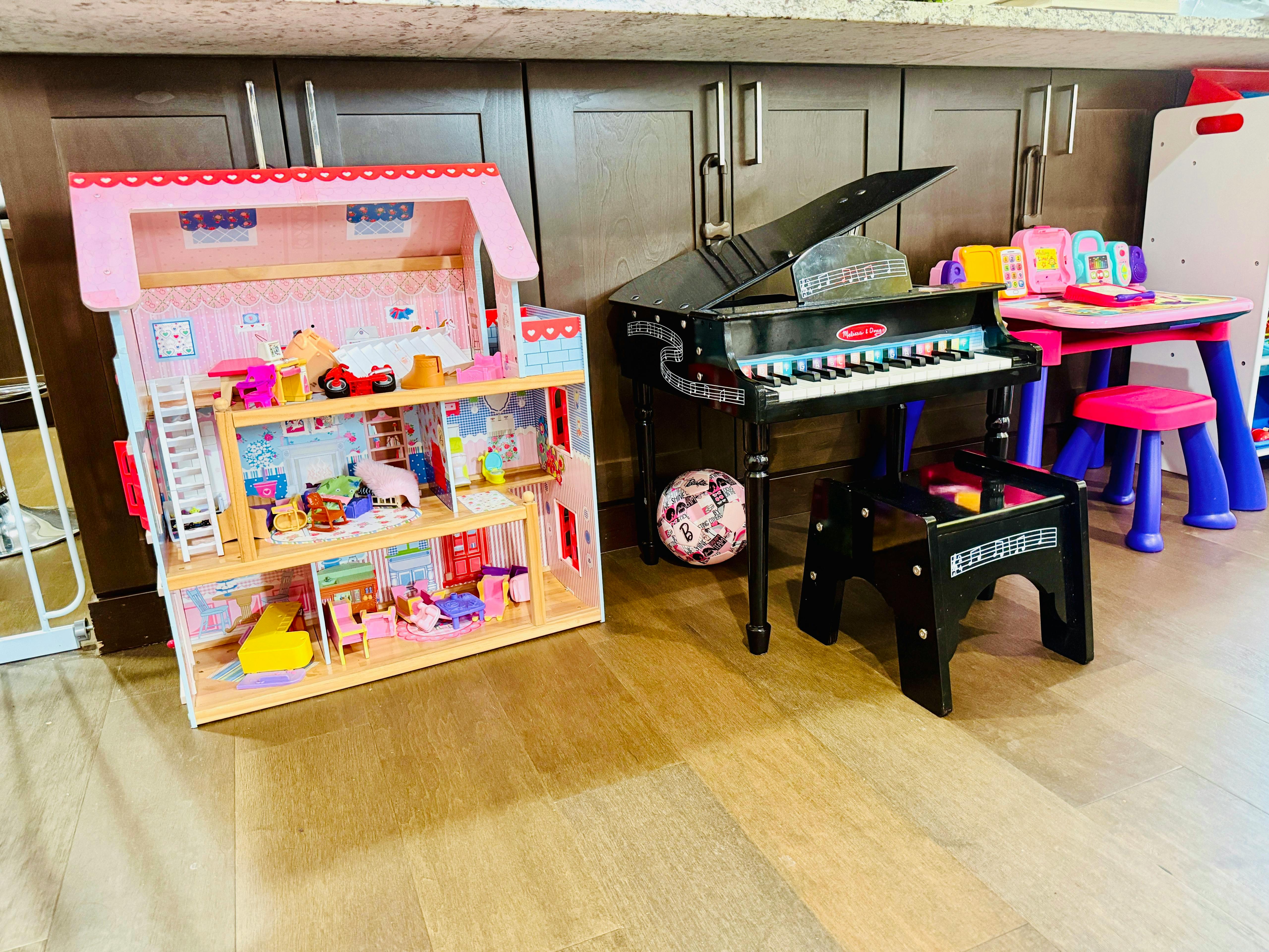Dollhouse, toy piano, and small table with chairs