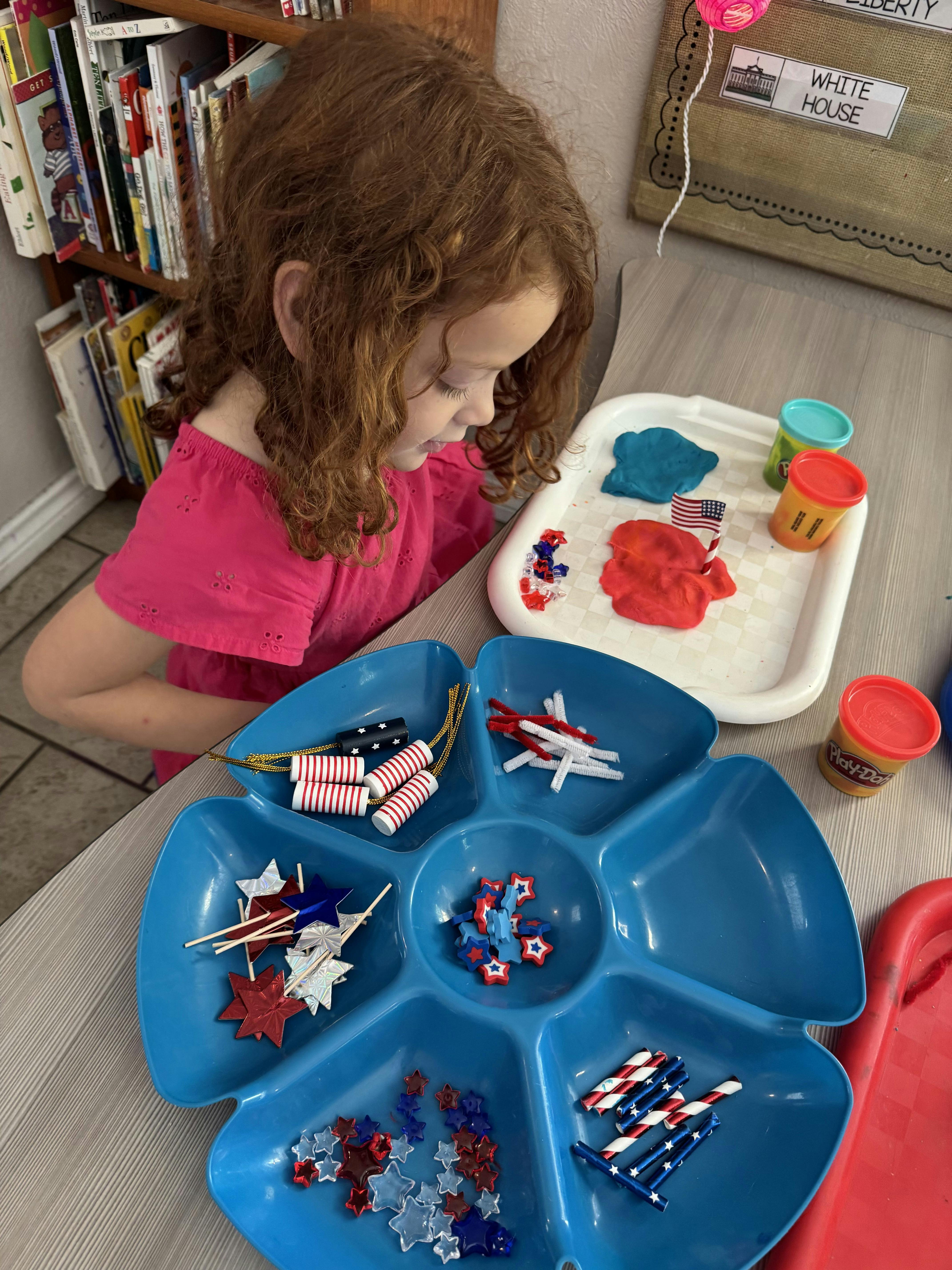 Child looking at craft supplies and playdough