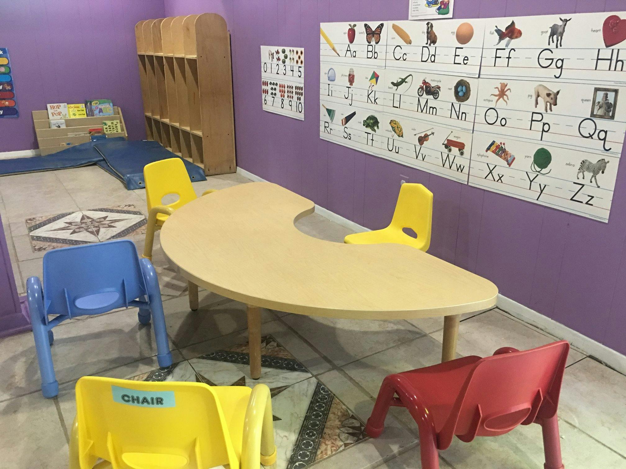 Classroom with a crescent-shaped table and colorful chairs