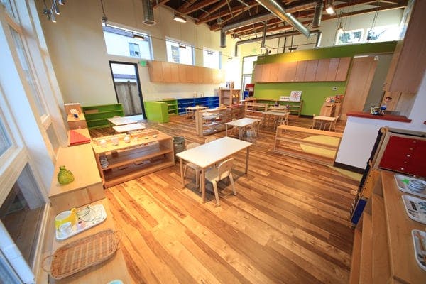 Empty classroom with small tables and chairs