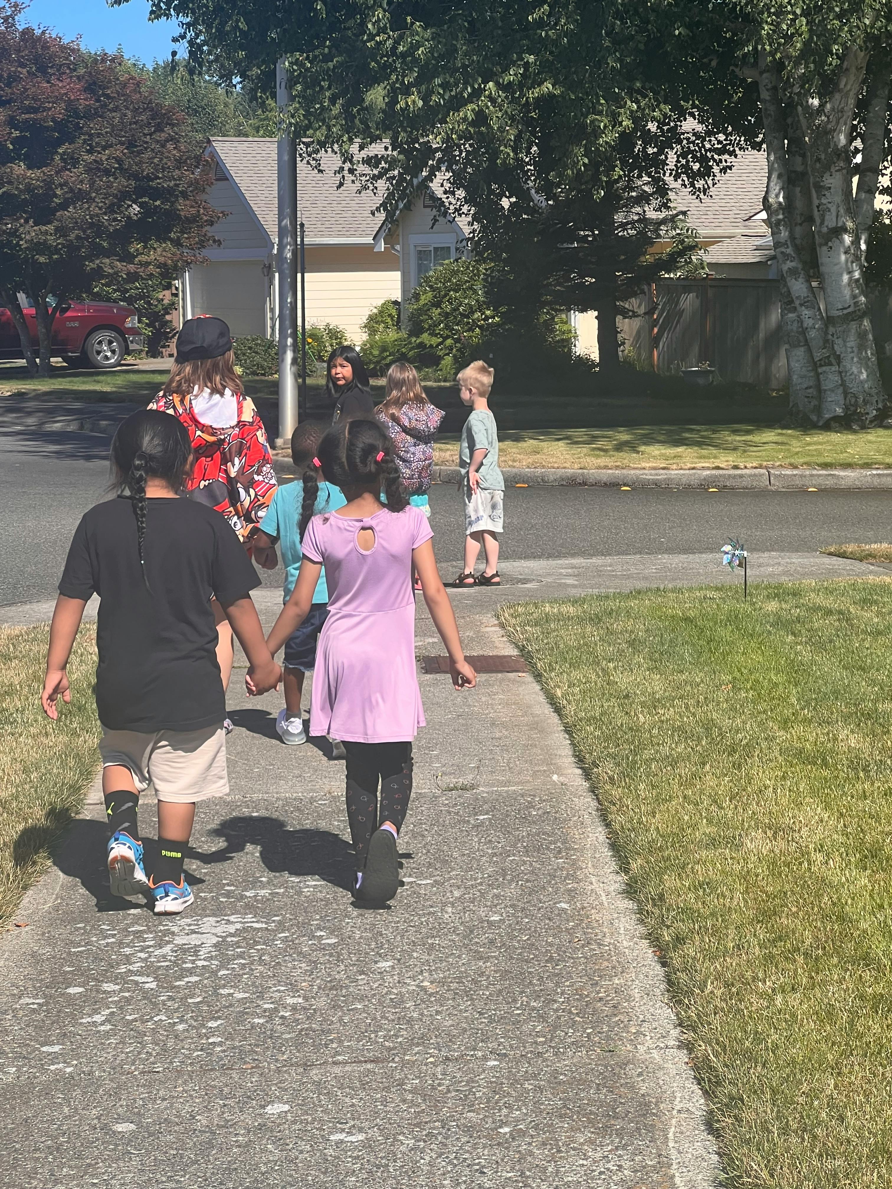 Group of children walking on a sidewalk