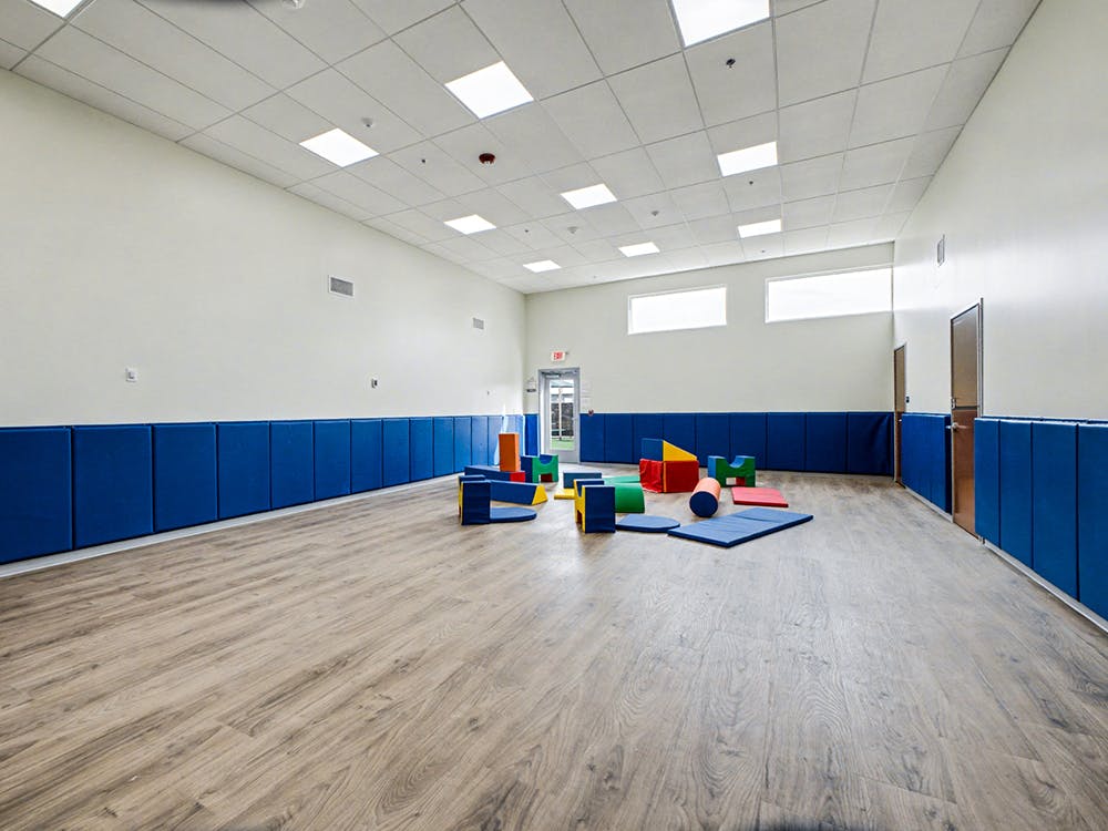 Empty activity room with soft play blocks on the floor