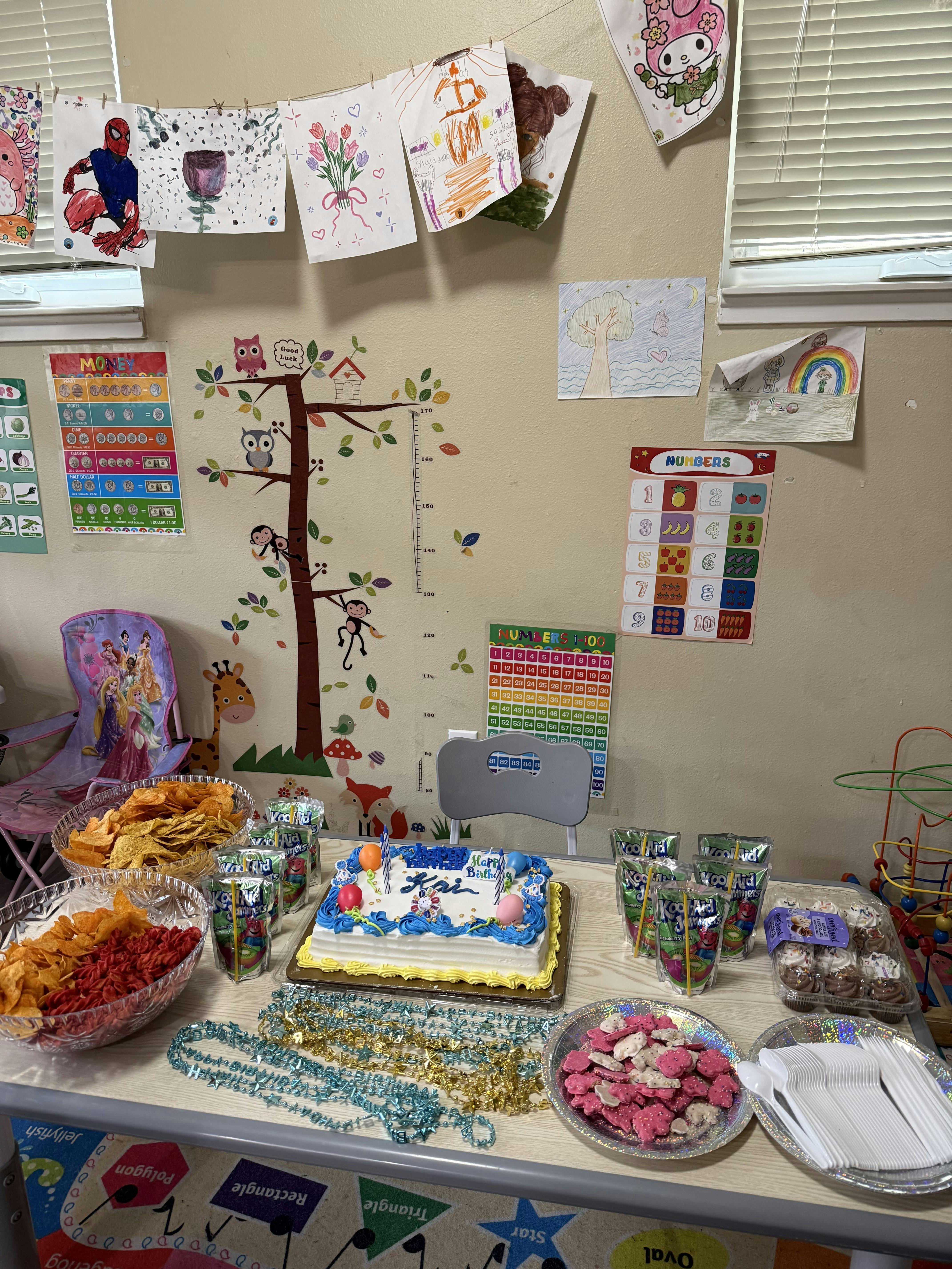 Birthday cake and snacks on a table in a decorated room