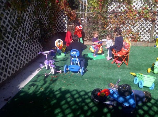 Adults and children playing with toys outdoors
