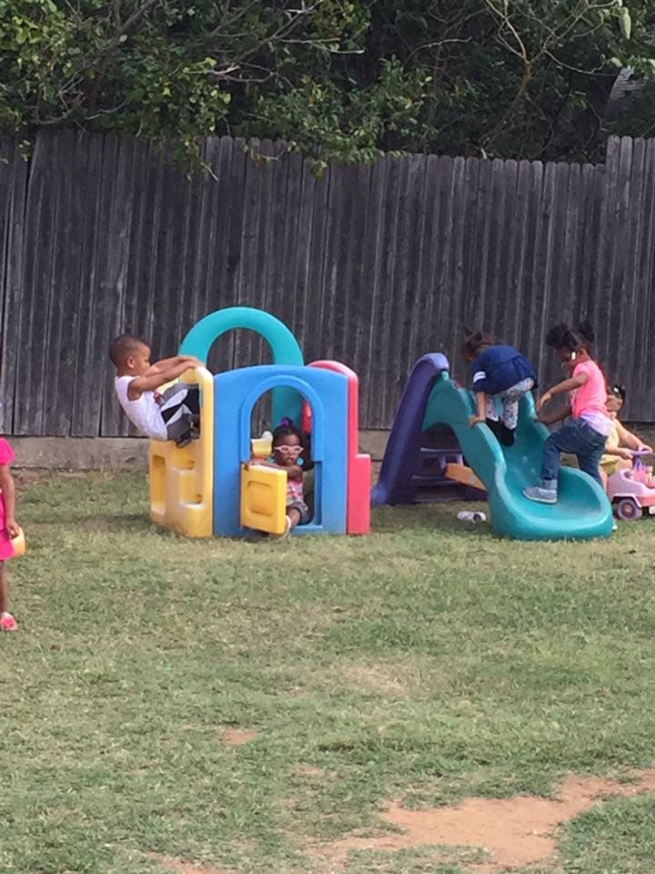 Children playing on colorful outdoor play equipment