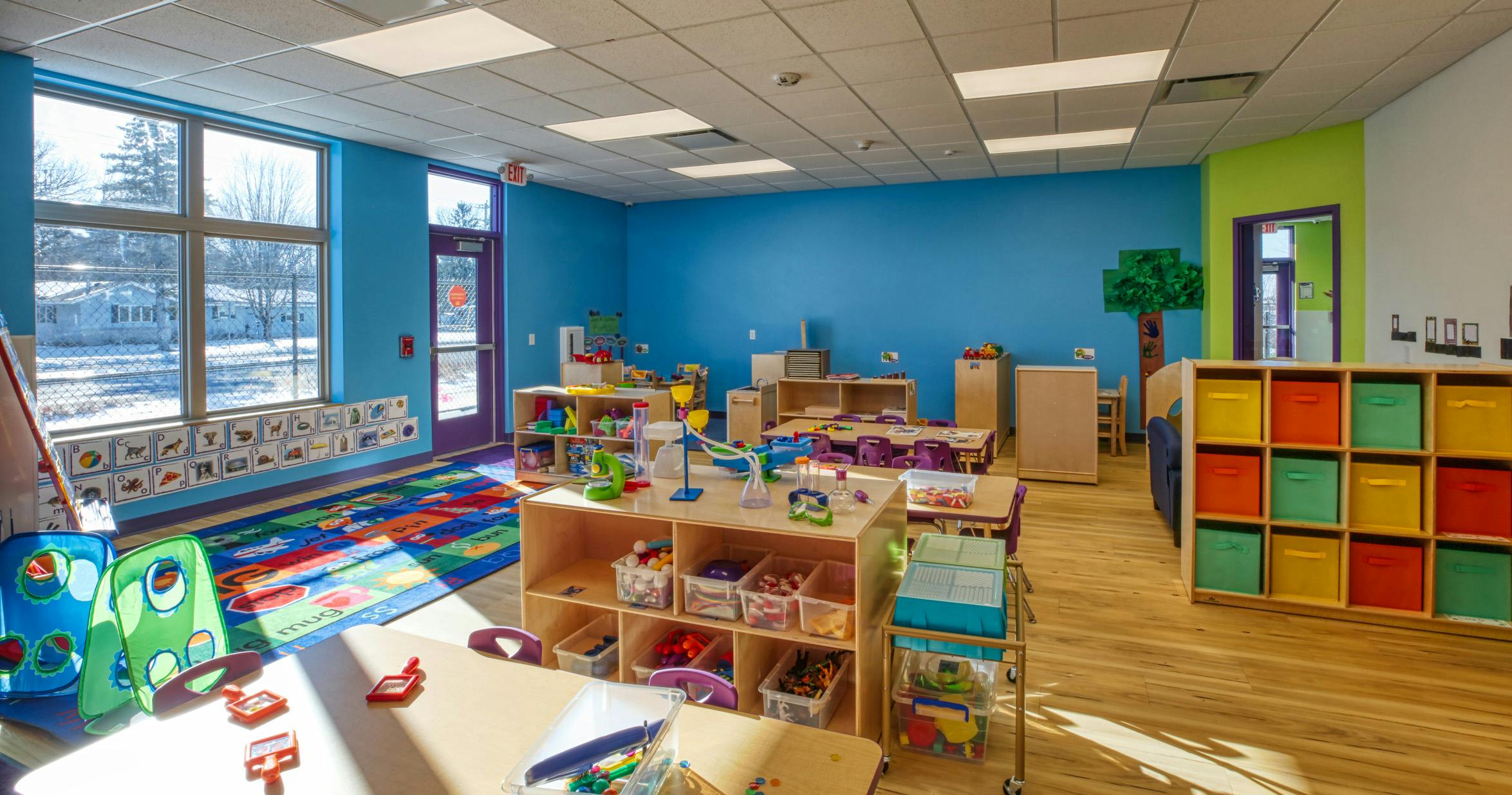 An empty early learning classroom with colorful walls and toys