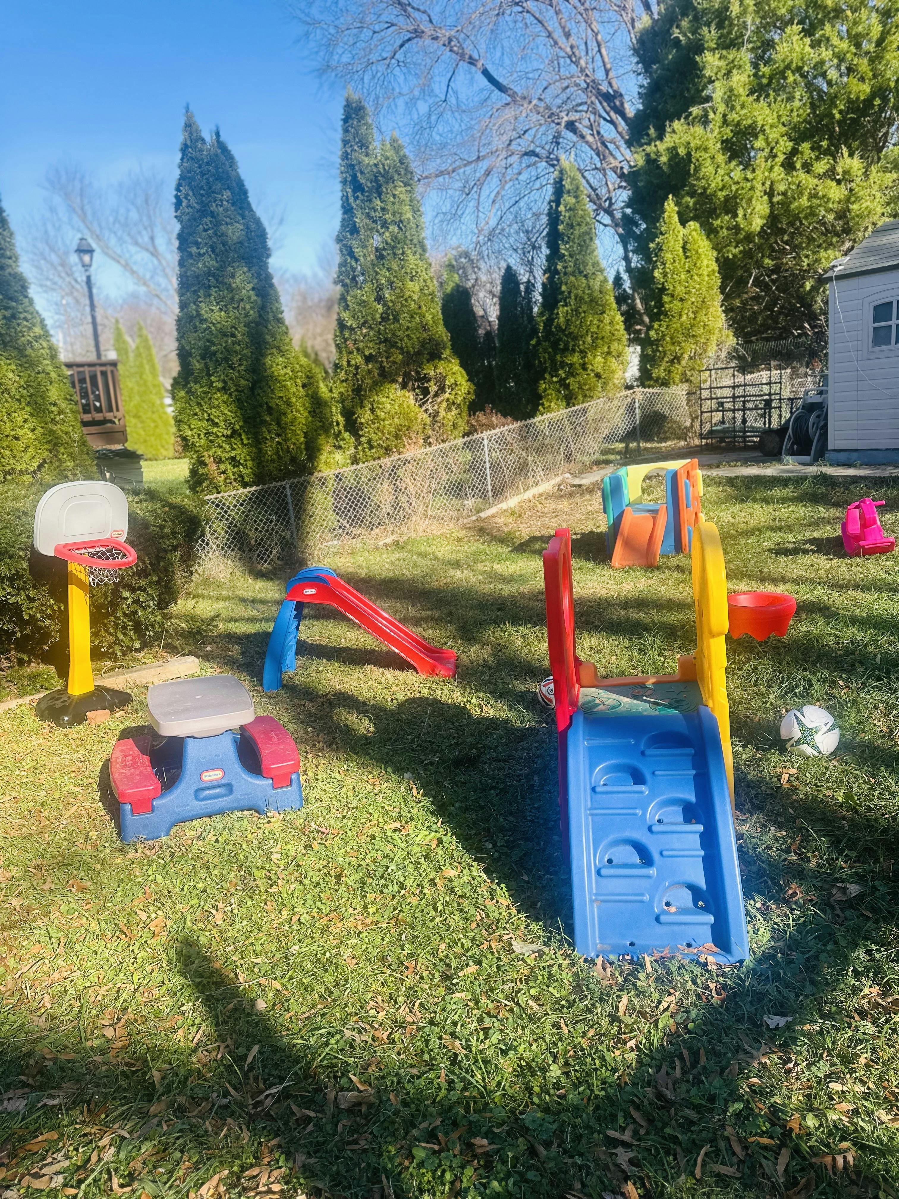 Children's play equipment in a grassy backyard