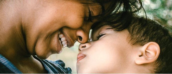 Person and child touching noses