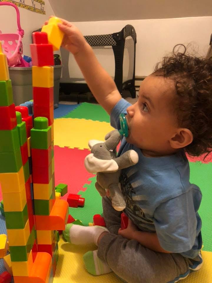 Child playing with colorful building blocks