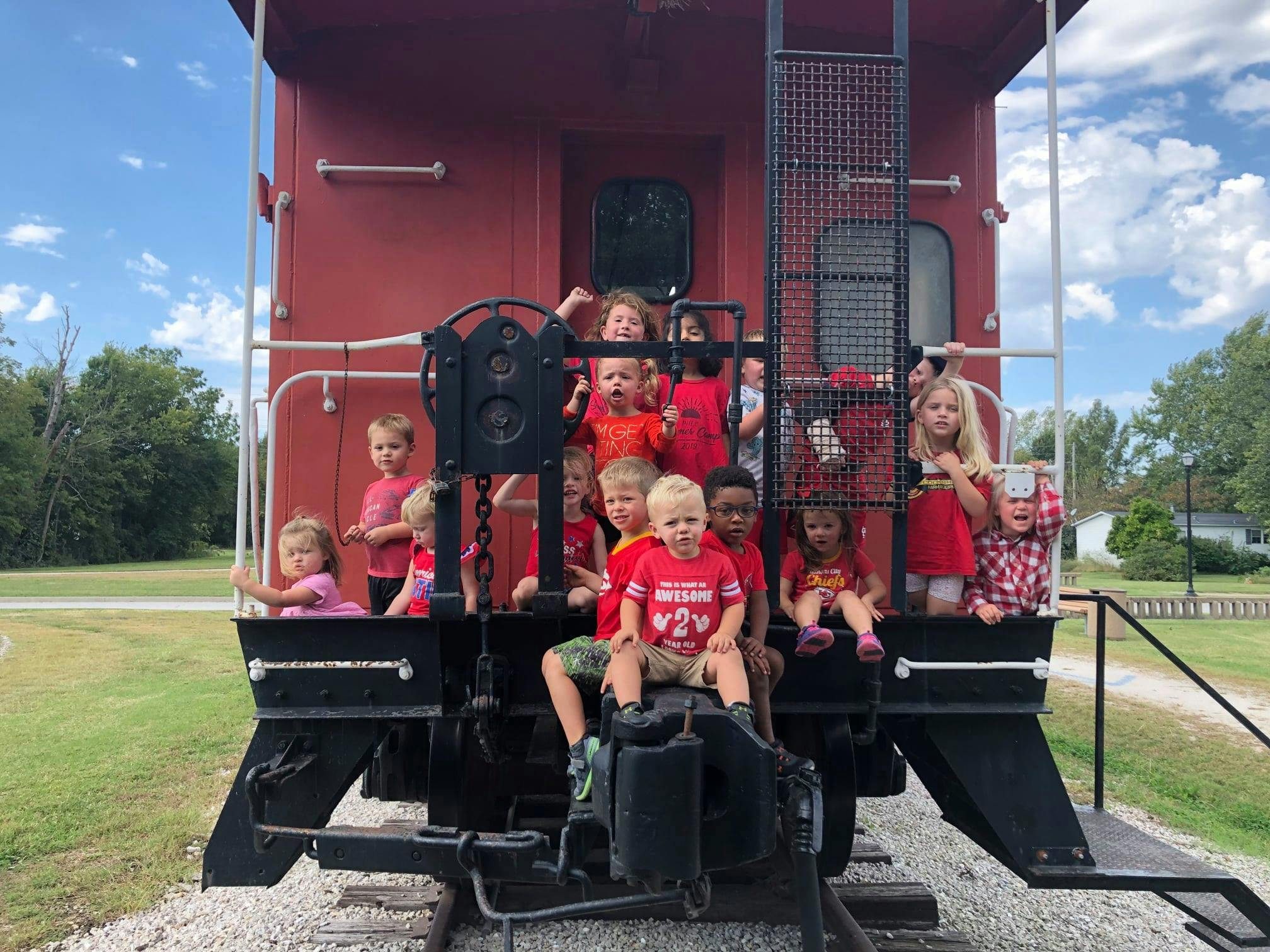 Children on the back of a red train car
