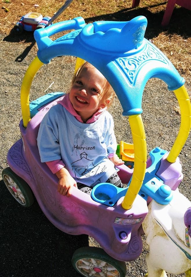 Child in a toy car