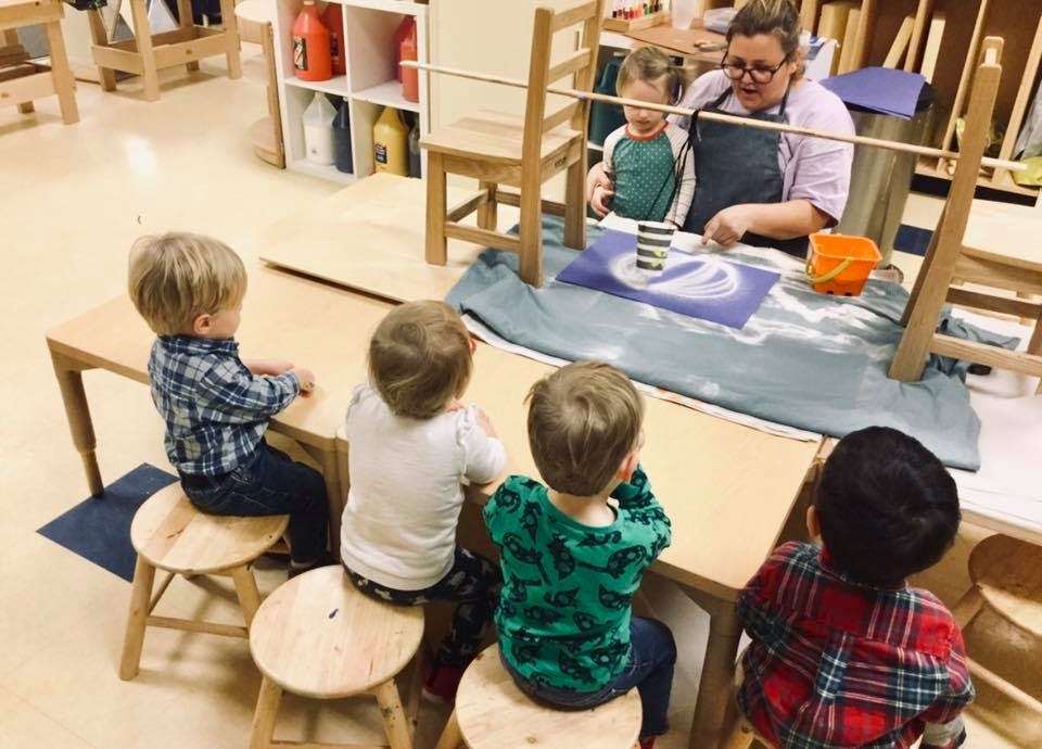 Adult and children at a table in a classroom