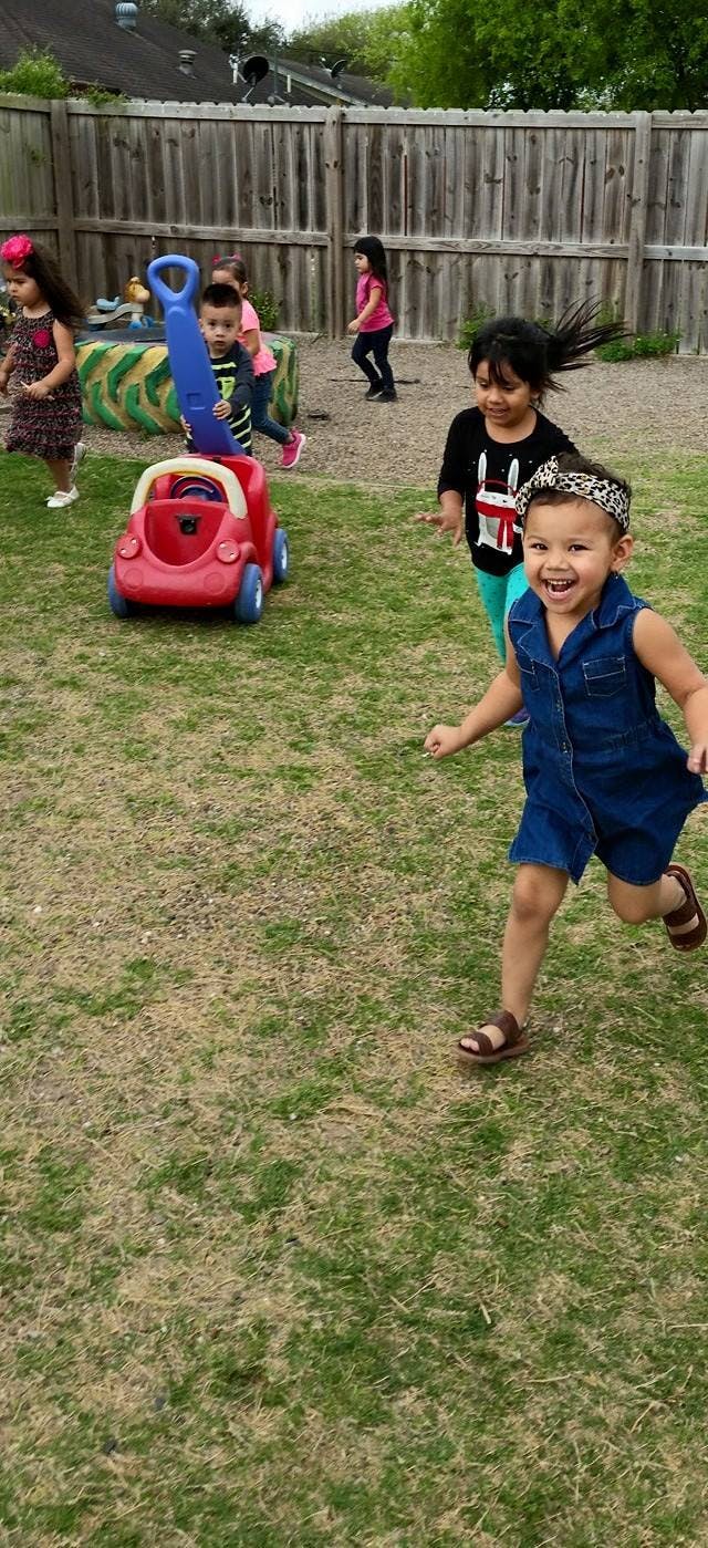 Children playing outdoors with a toy car