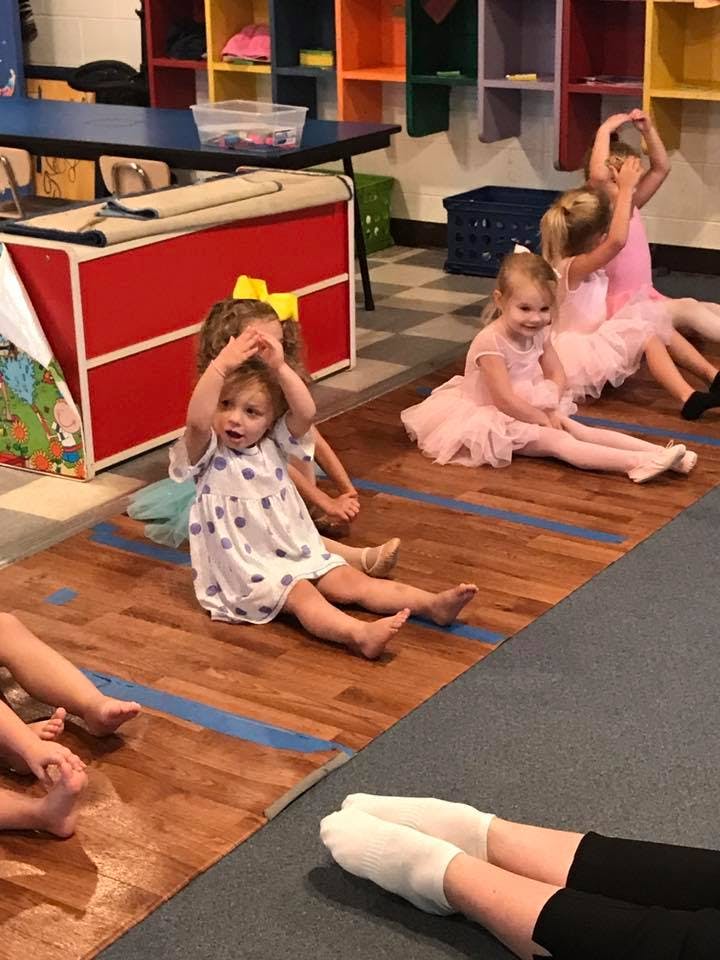 Children sitting on the floor in a classroom