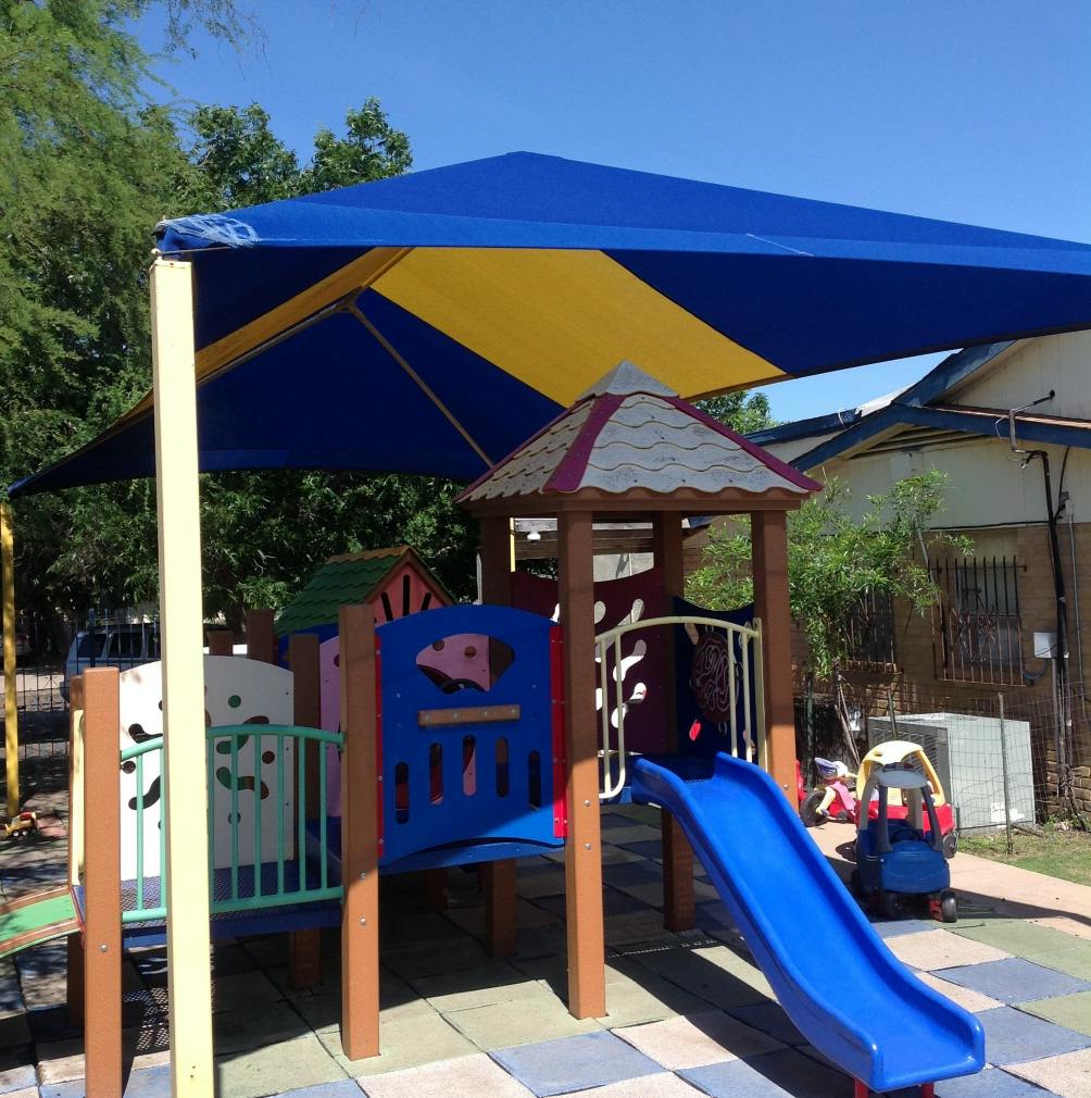 Playground with blue slide and blue and yellow shade structure