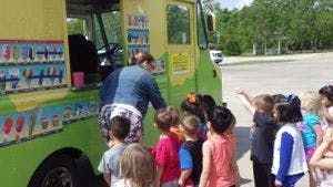 Person serving children from a food truck