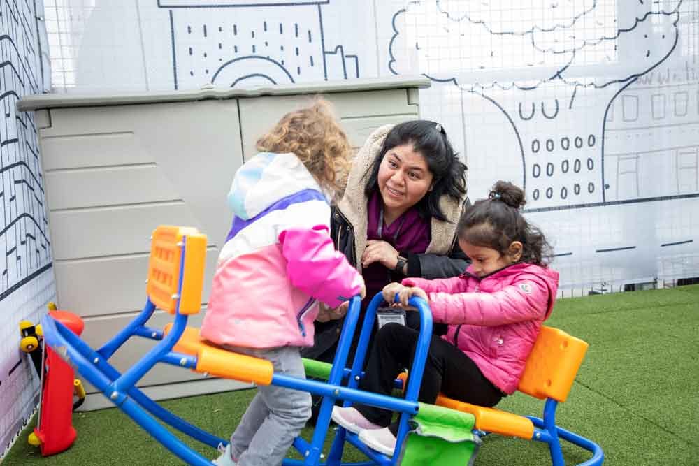 Person and two children on a seesaw