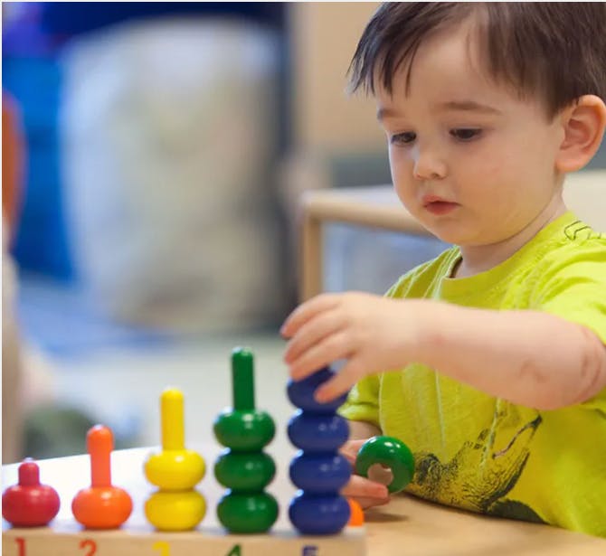 Child playing with a stacking toy