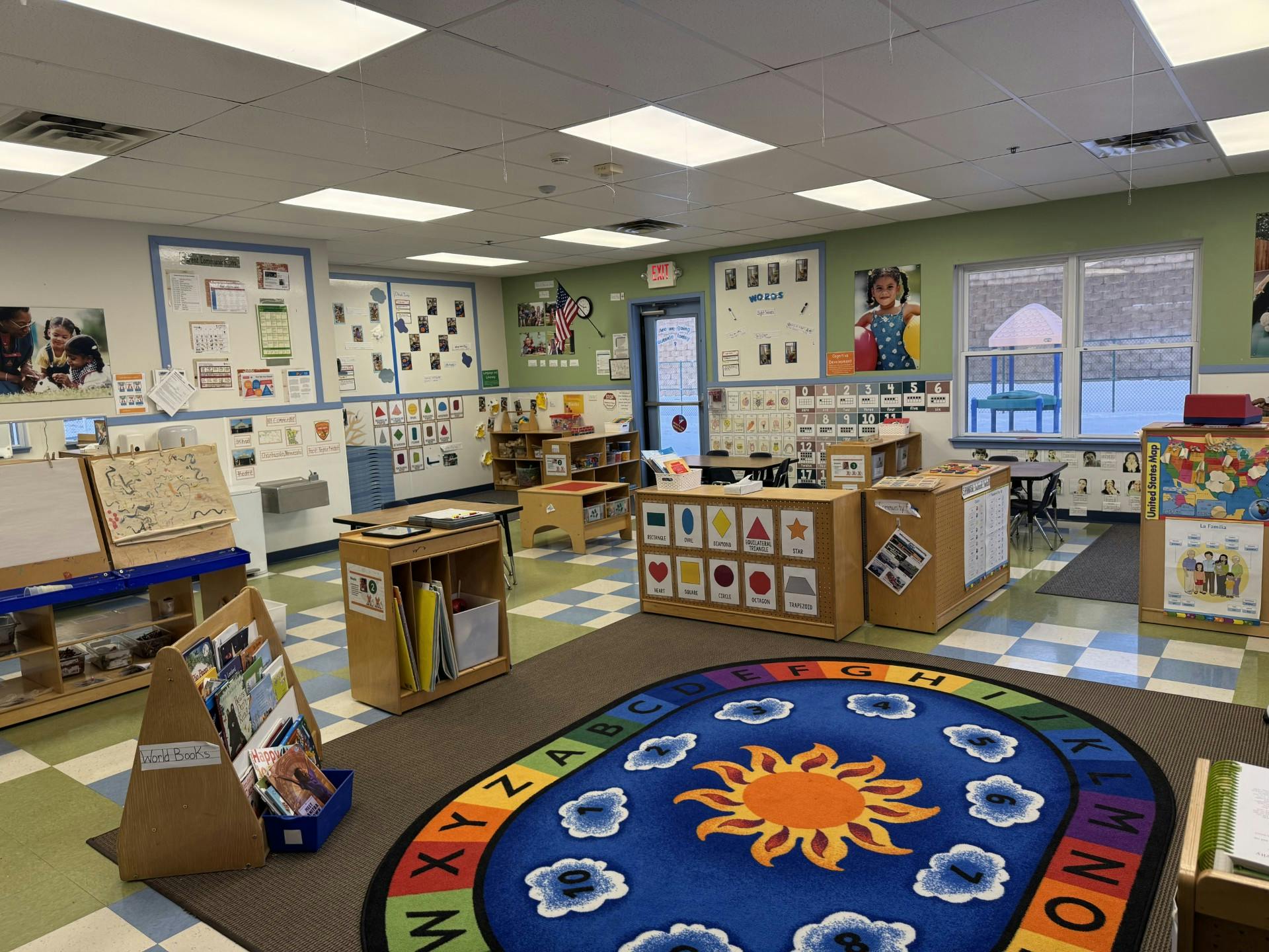 Colorful classroom with a large sun and alphabet rug