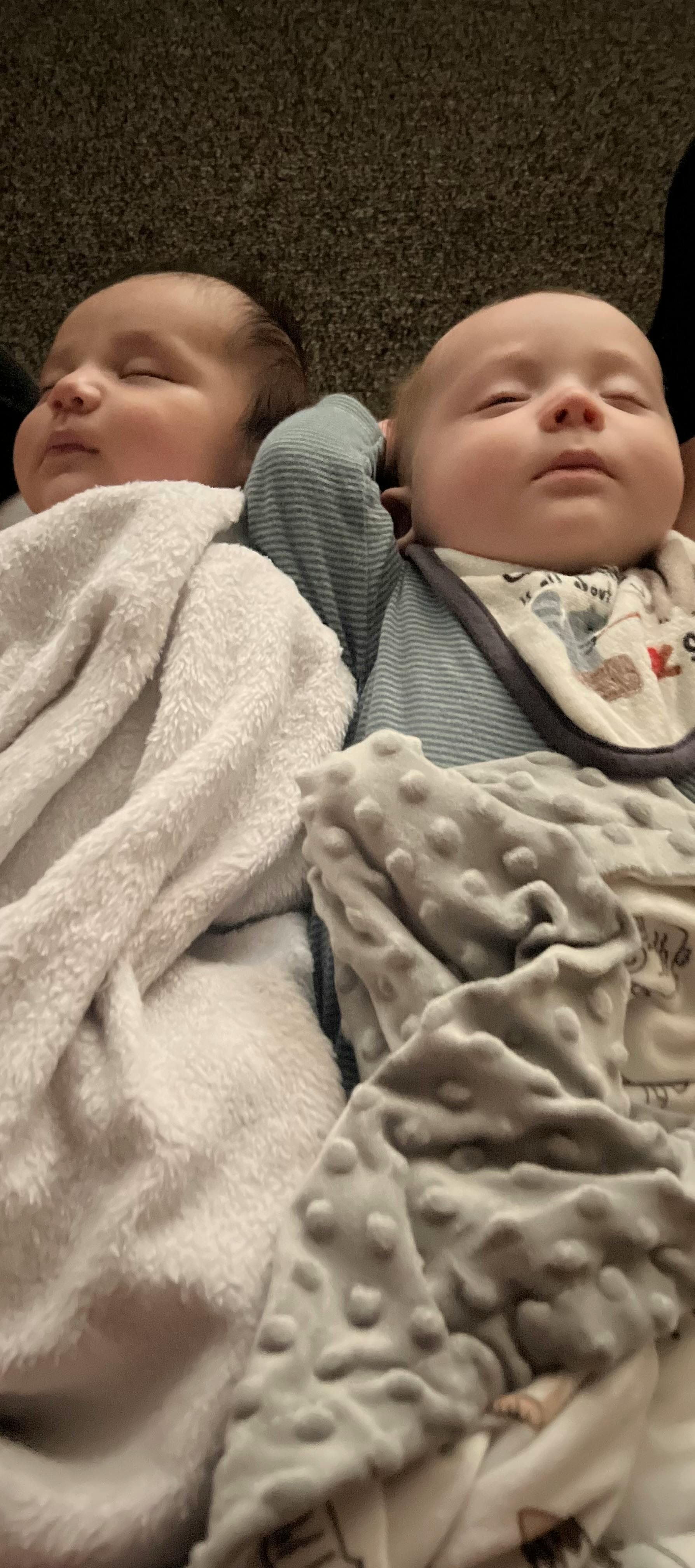 Two sleeping babies wrapped in blankets