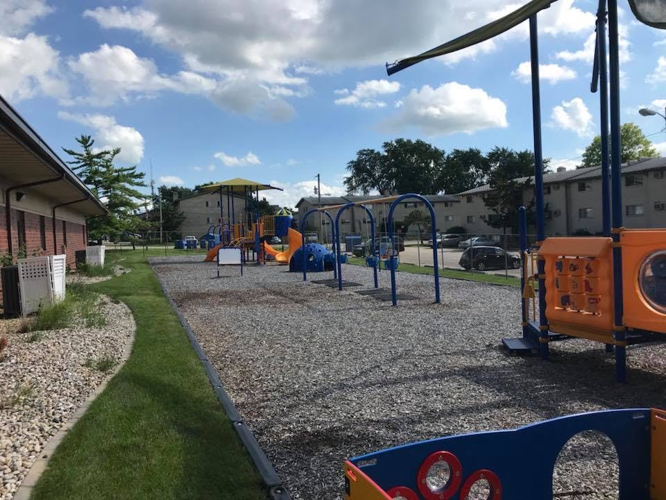 Outdoor playground with various equipment on a sunny day