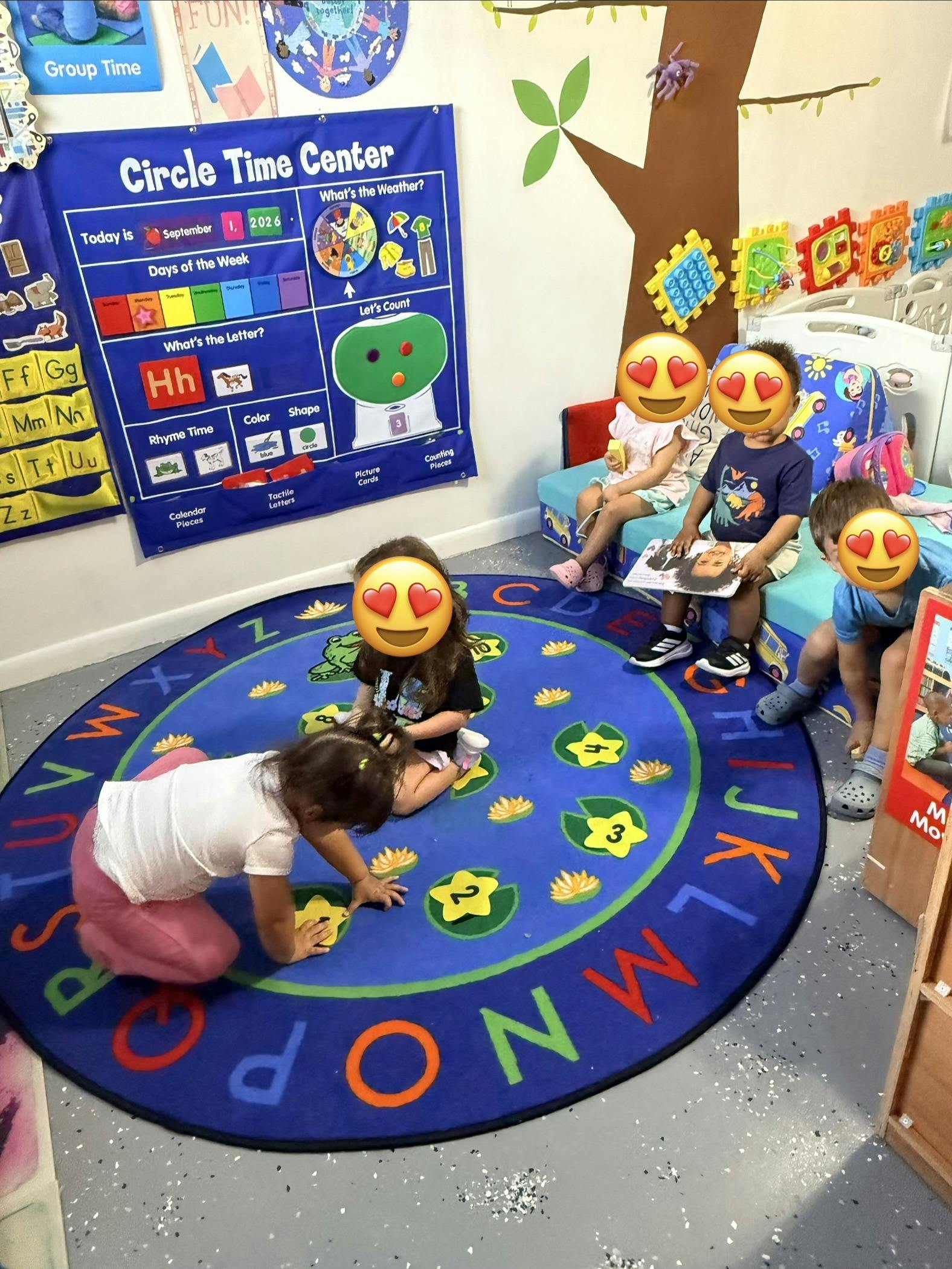 Children playing in a preschool classroom activity area