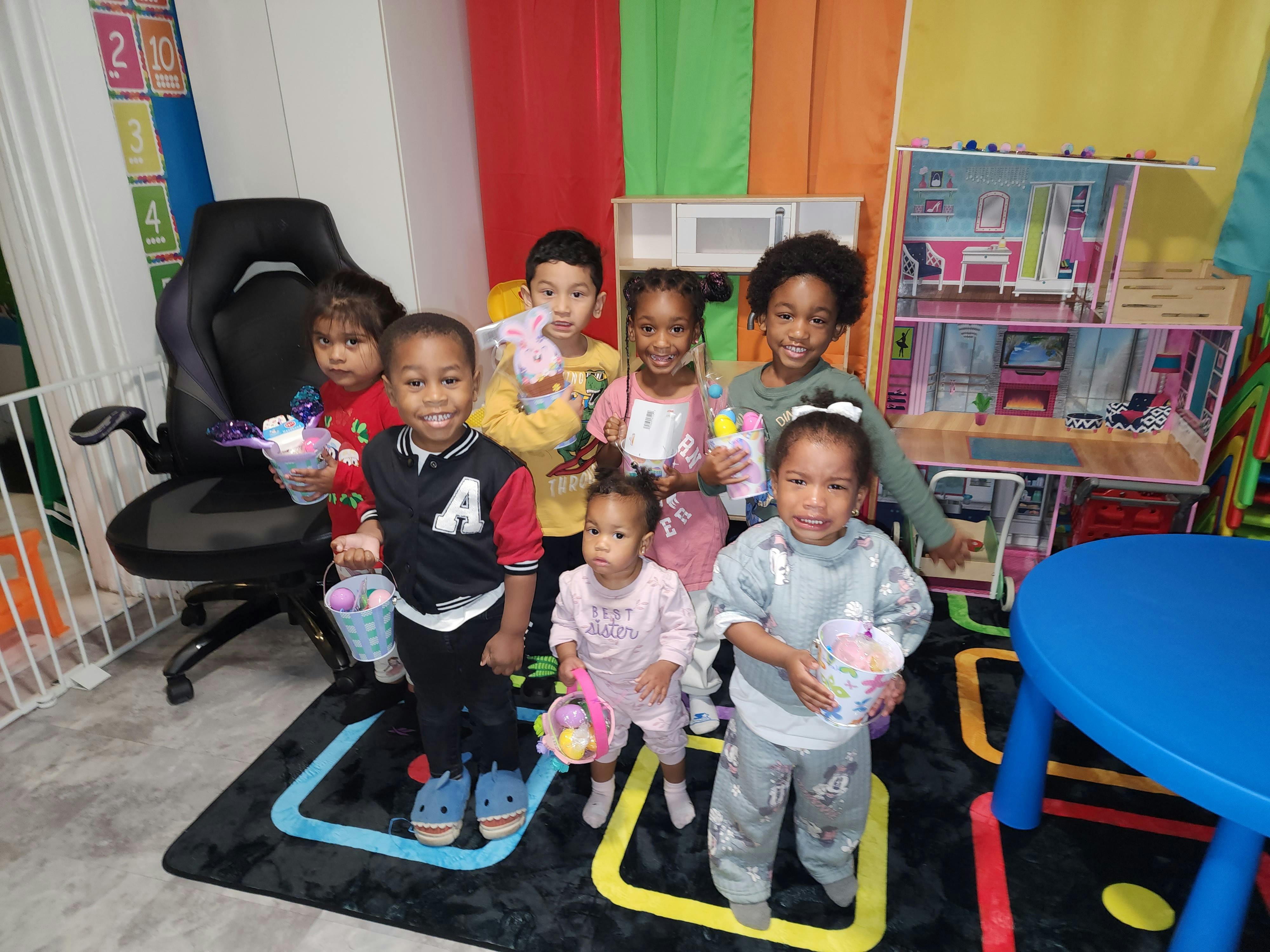 Seven children holding Easter baskets and toys