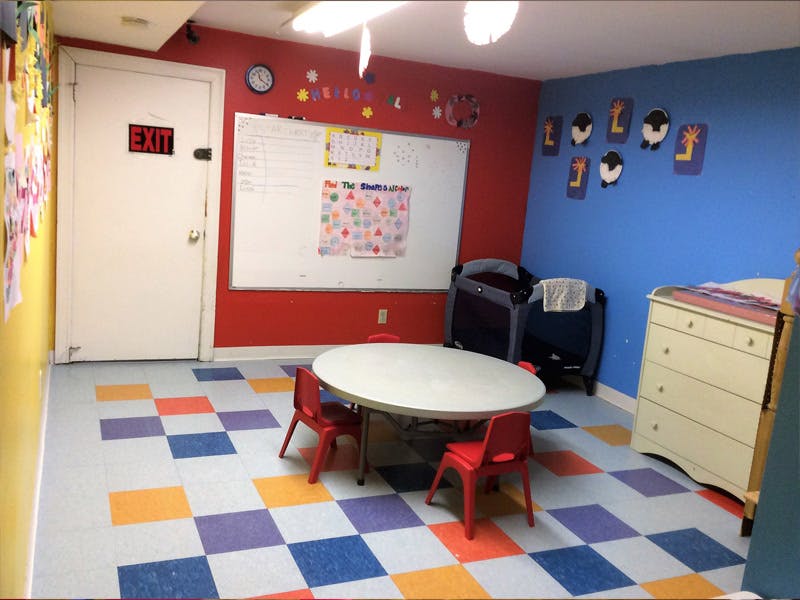 Children's classroom with colorful walls and floor, small table and chairs