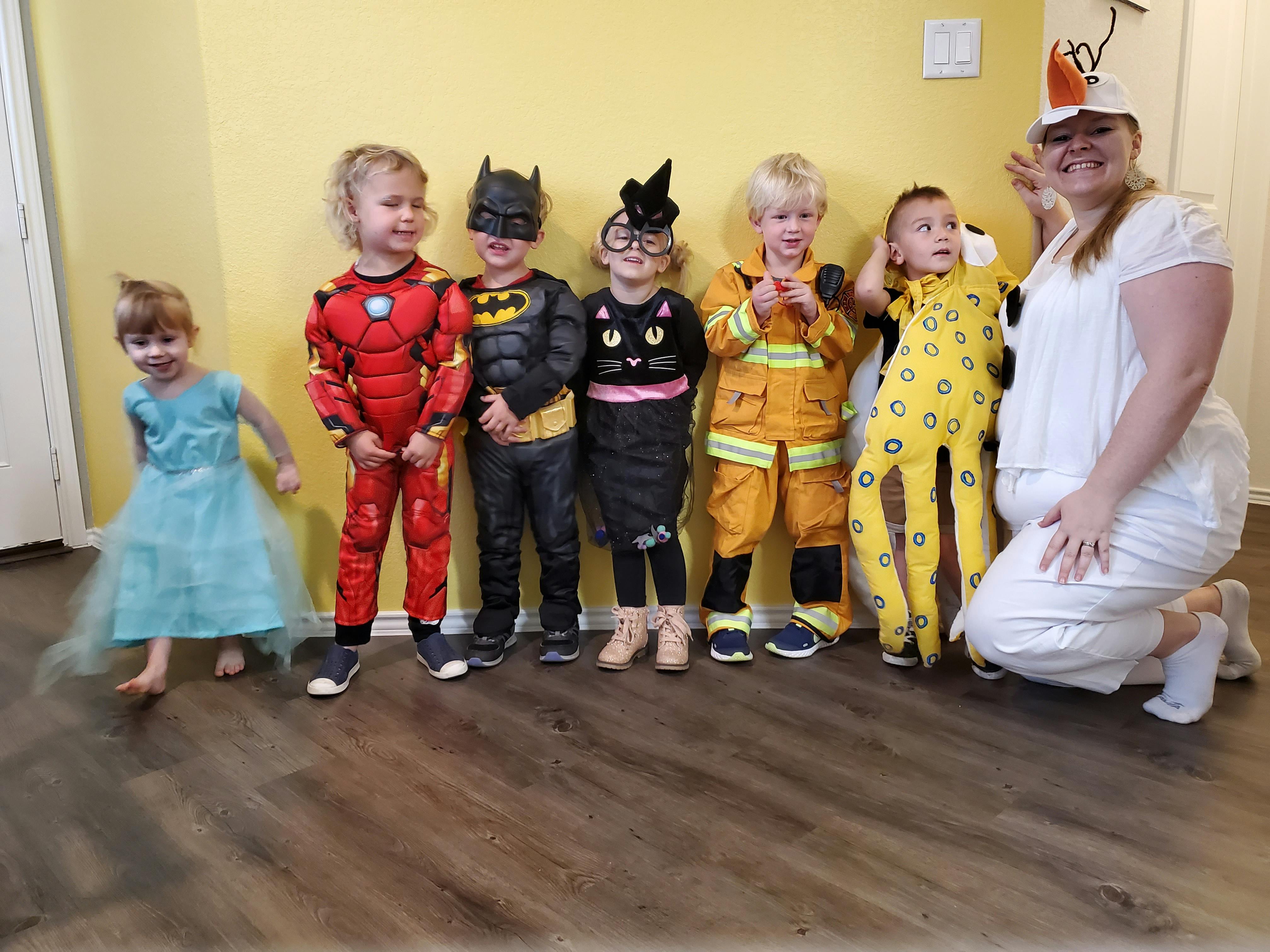 Adult and children in costumes standing in a line