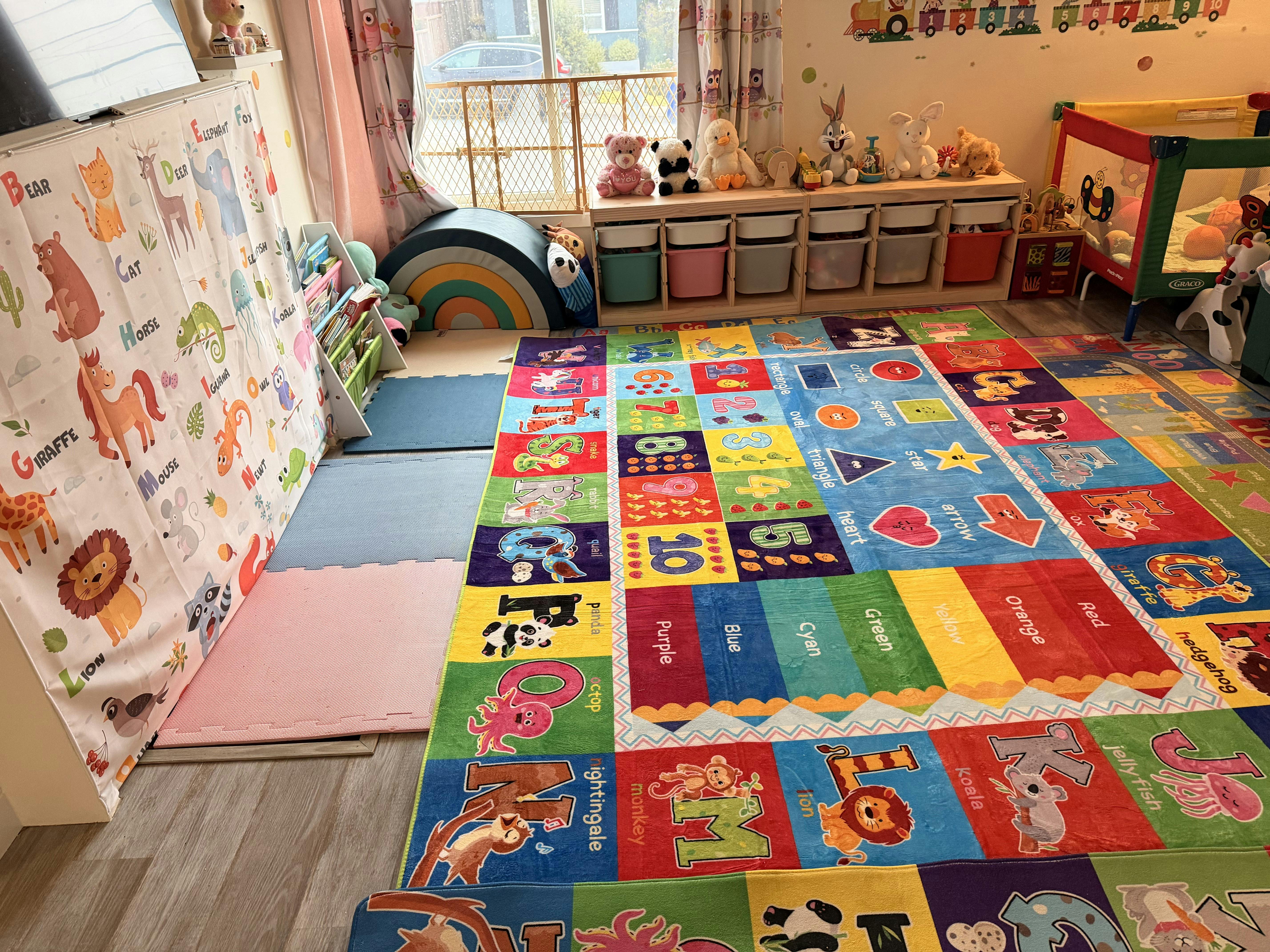 Children's playroom with colorful alphabet and numbers rug, shelves with toys