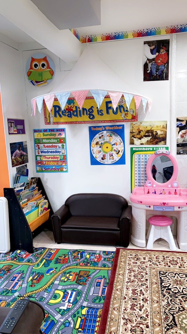 Children's play area with a small couch, bookshelf, and toy vanity