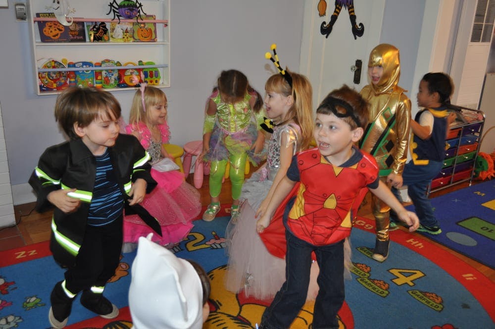 Children in costumes playing indoors