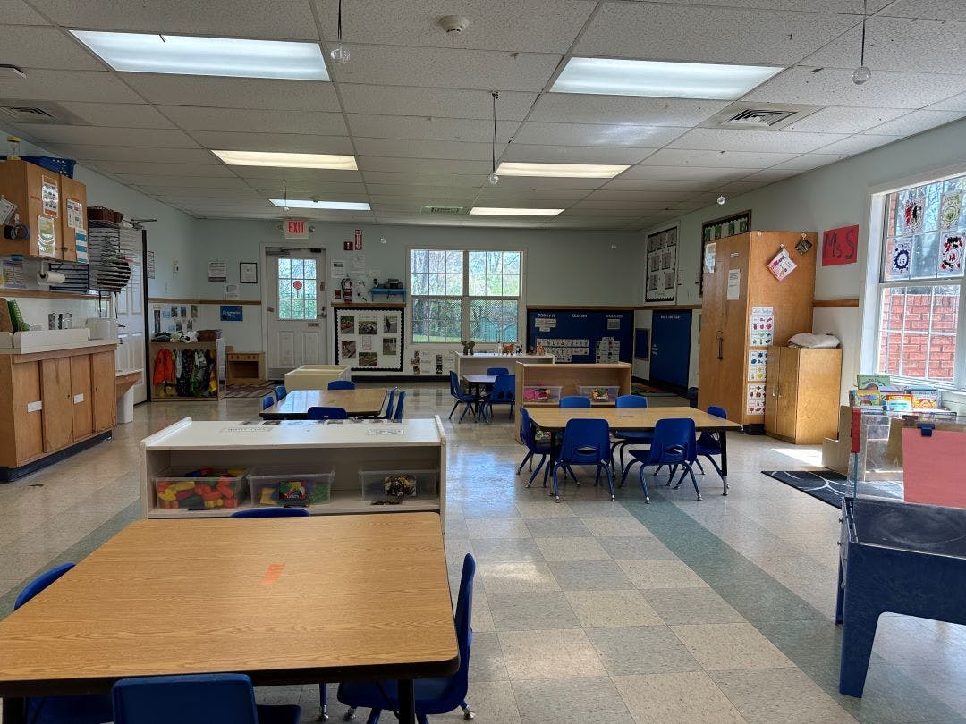 Empty classroom with small tables and chairs