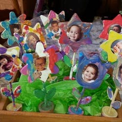 Craft flowers with photos of children in the center