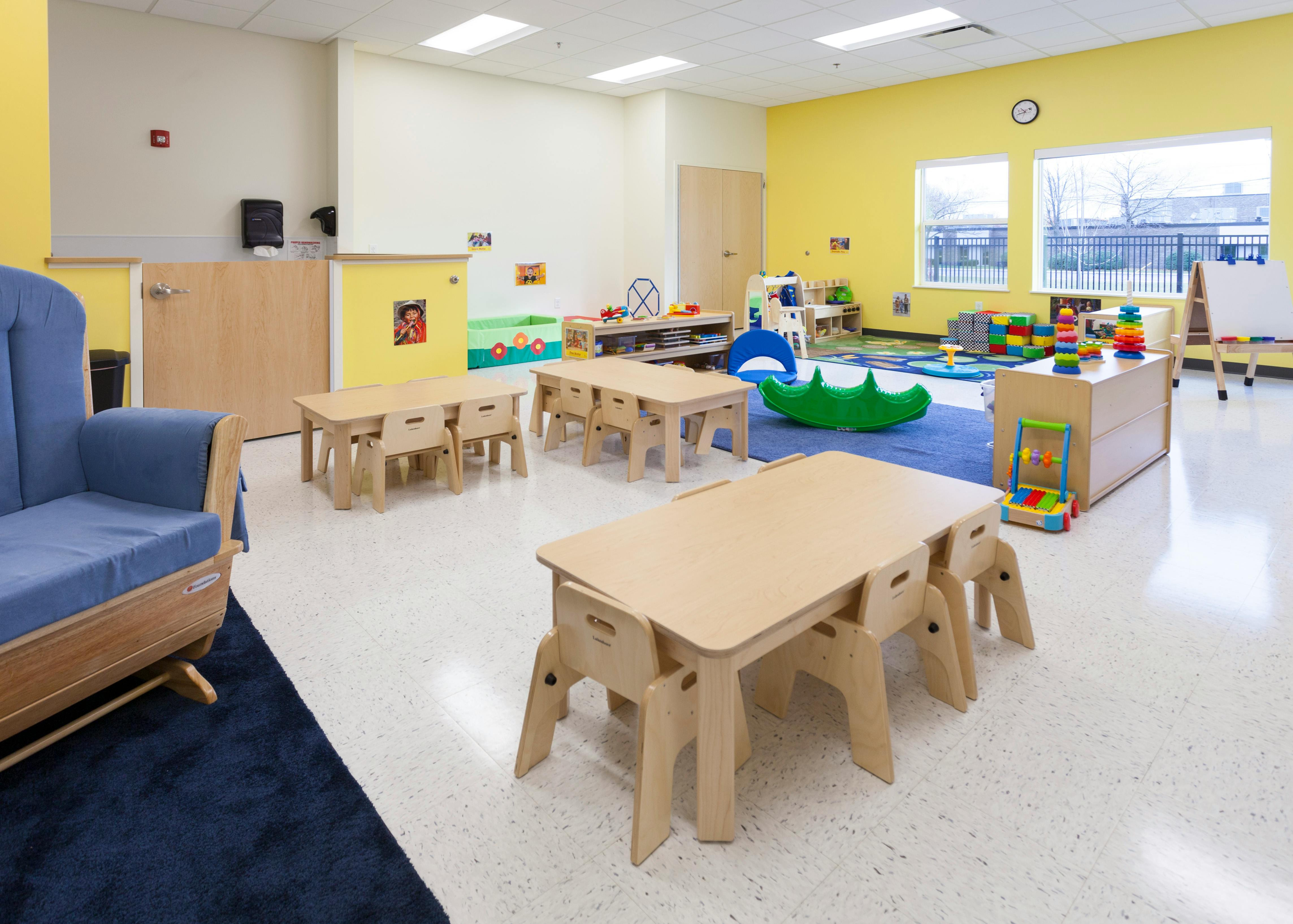 Empty classroom with small tables and chairs