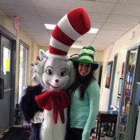 Person in Cat in the Hat costume next to person in striped hat