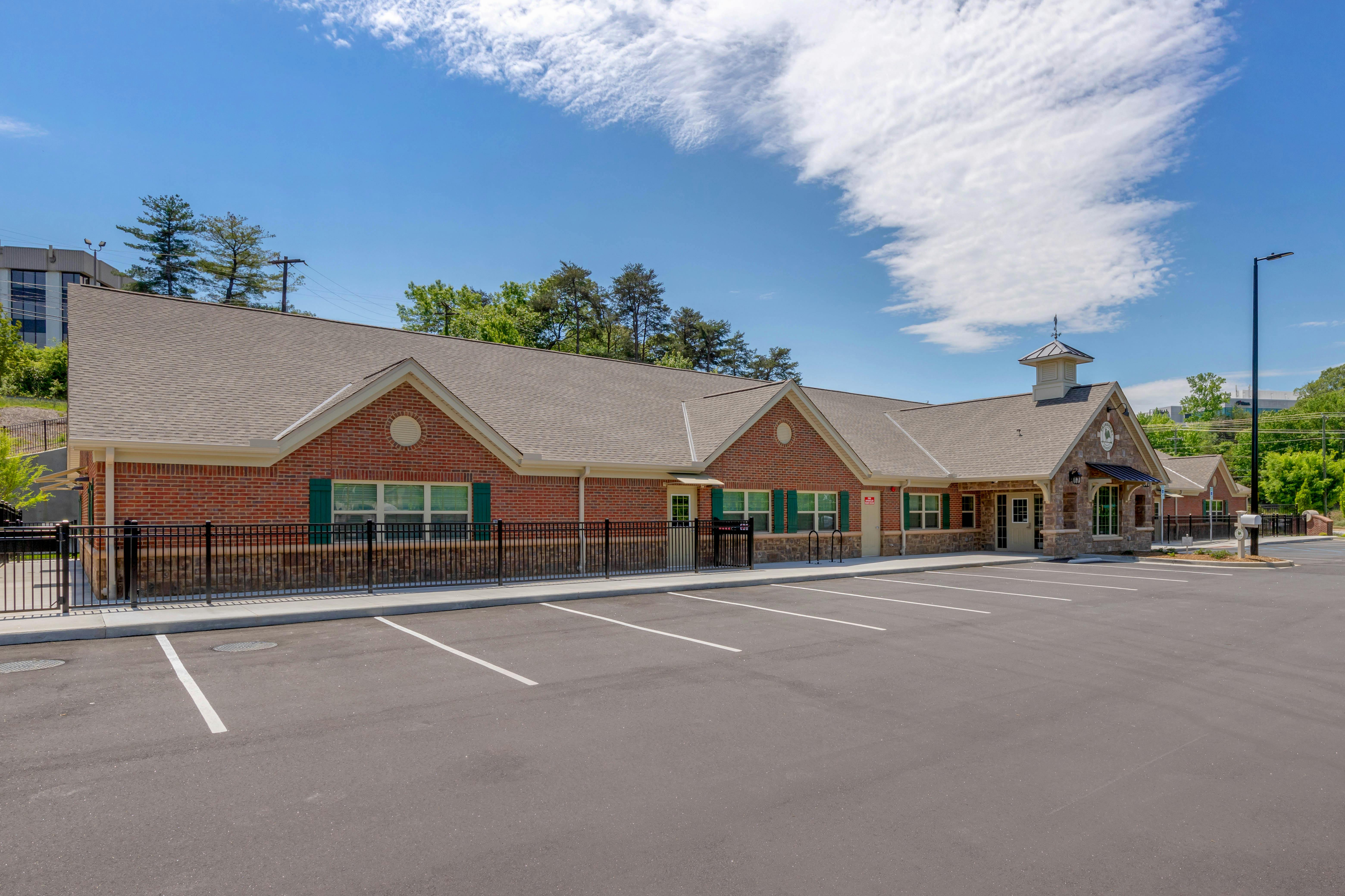Brick building with a parking lot in front