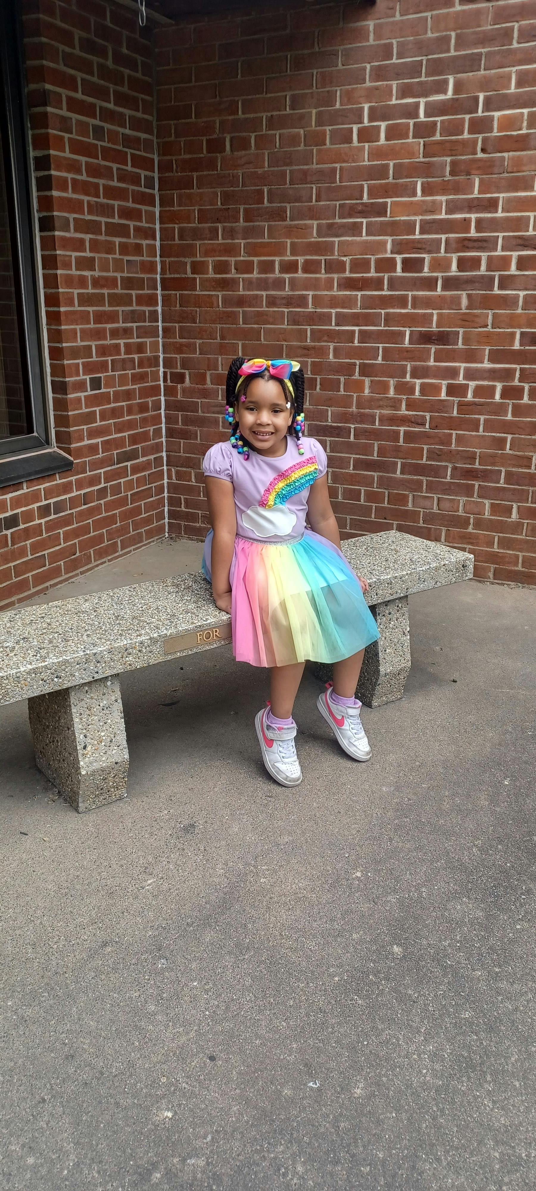 Child sitting on a stone bench