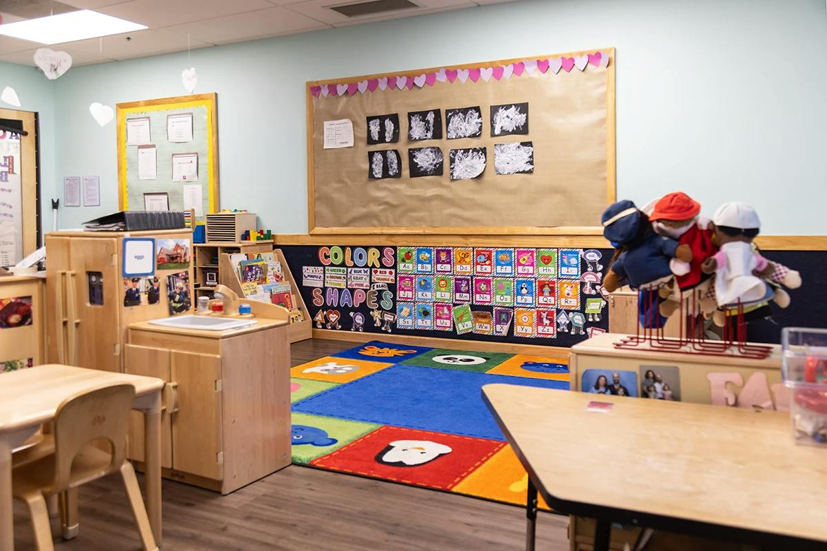Colorful rug and educational displays inside a preschool classroom