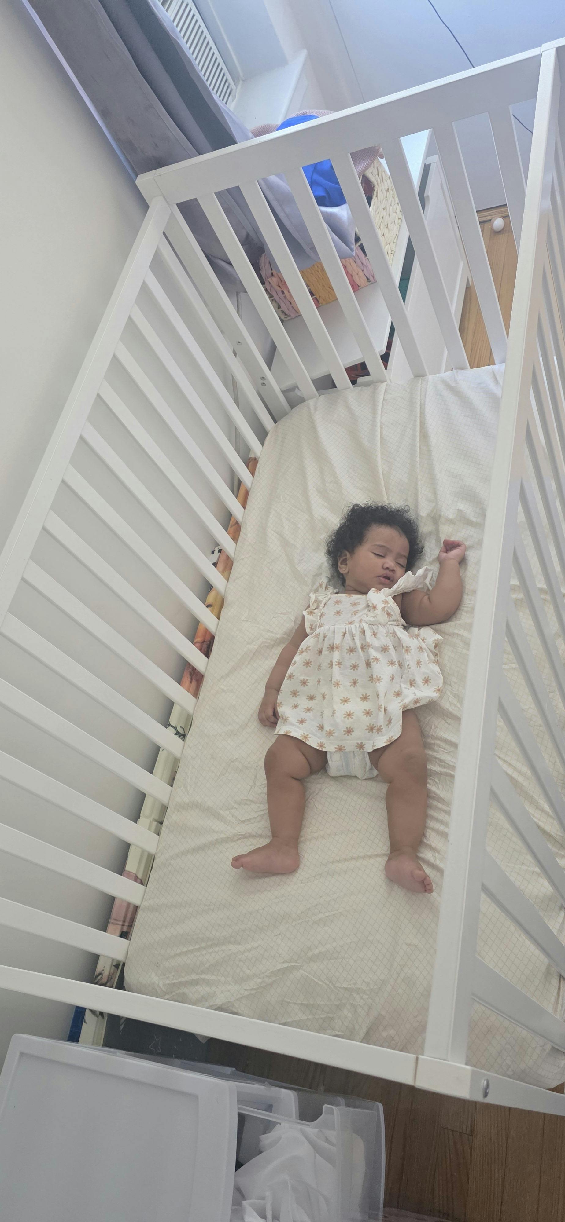 A child sleeping in a white crib