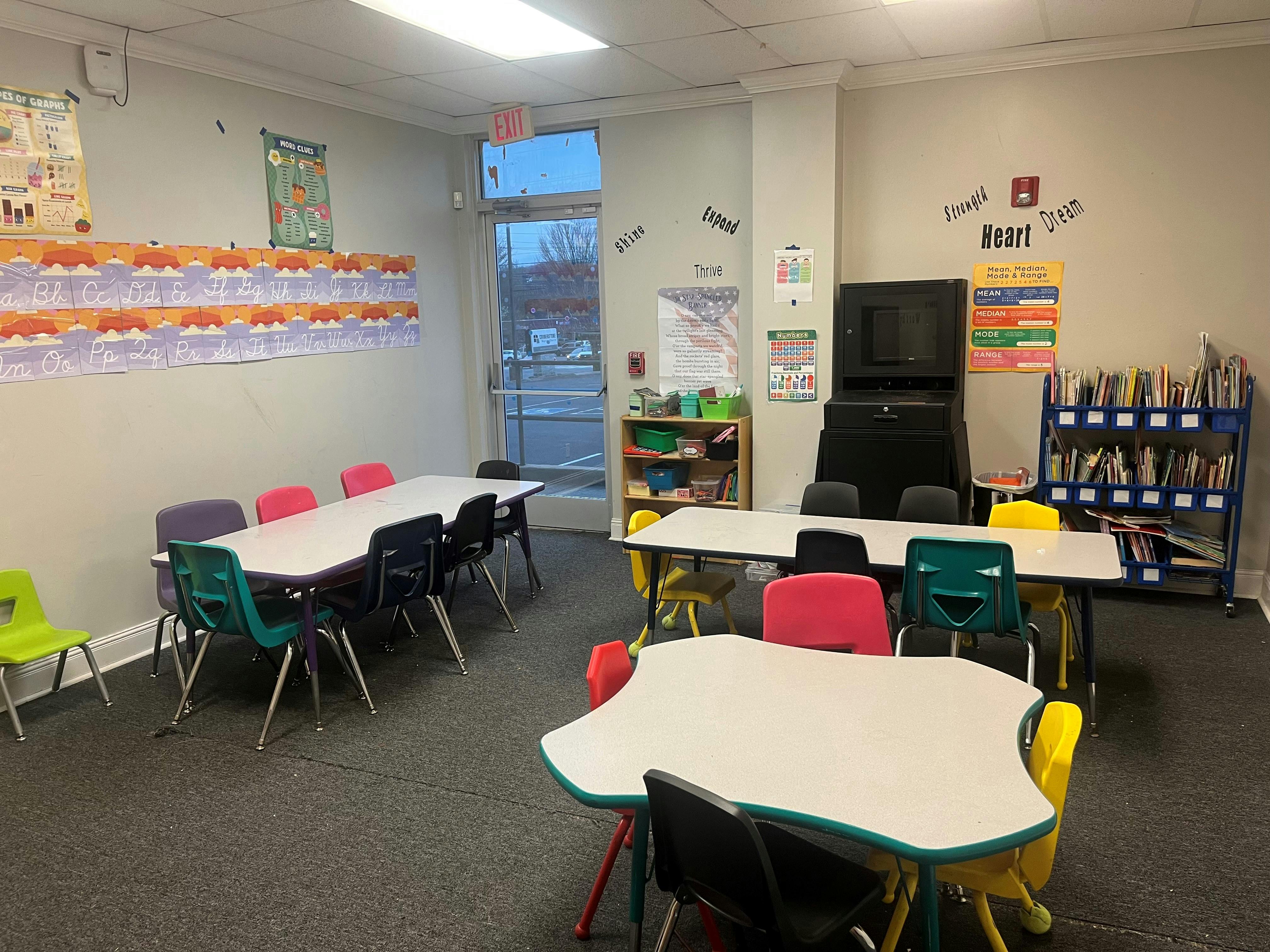 Children's classroom with small tables and colorful chairs