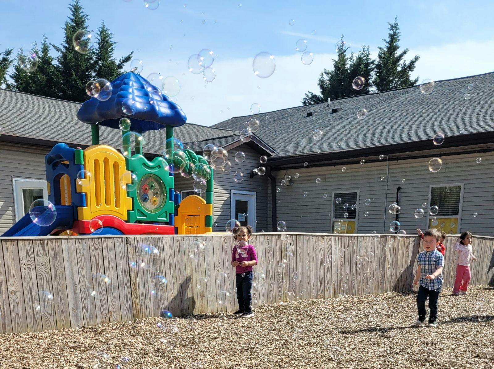 Children playing with bubbles on a playground