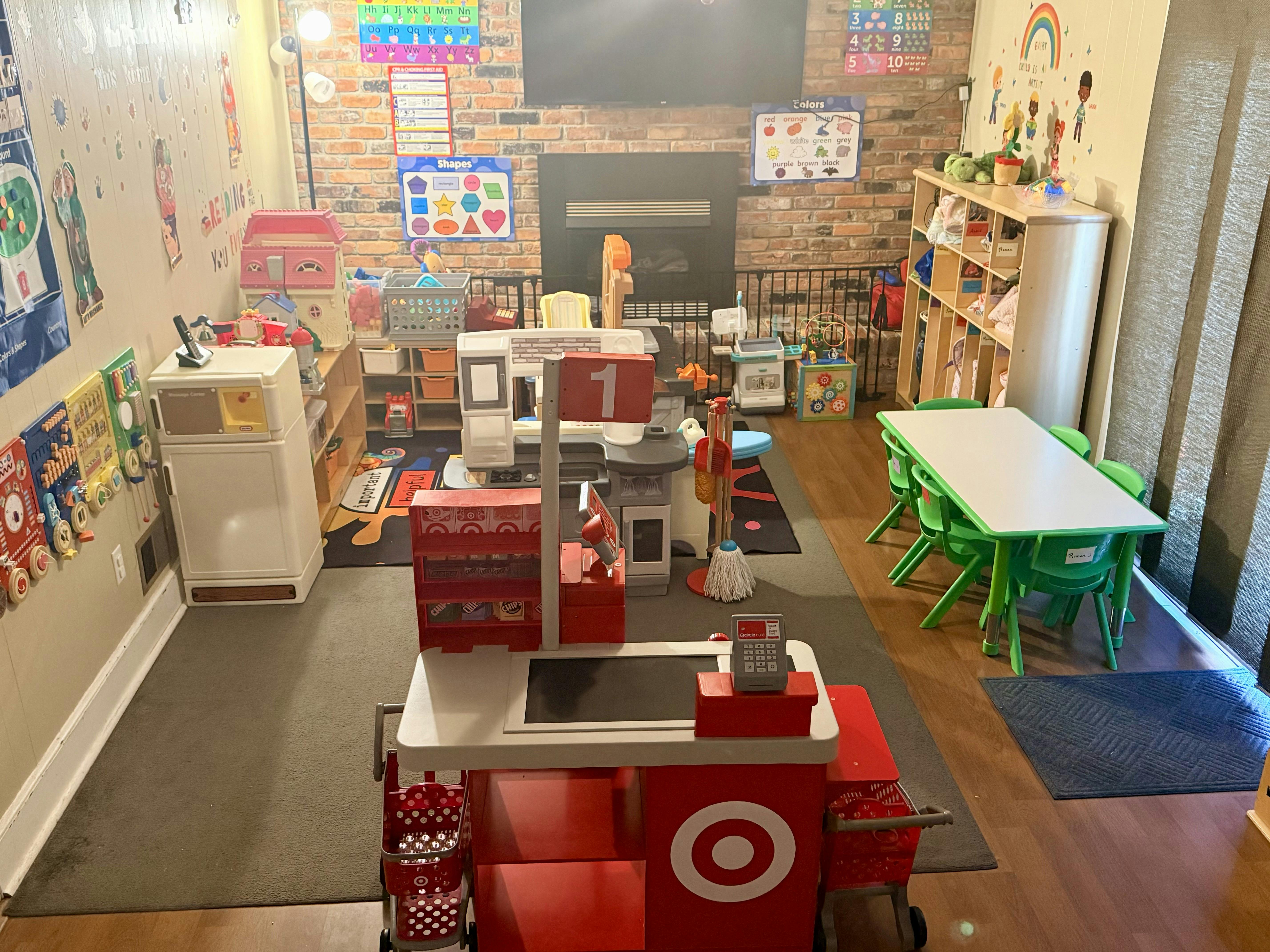 Playroom with various toys and learning charts on the walls