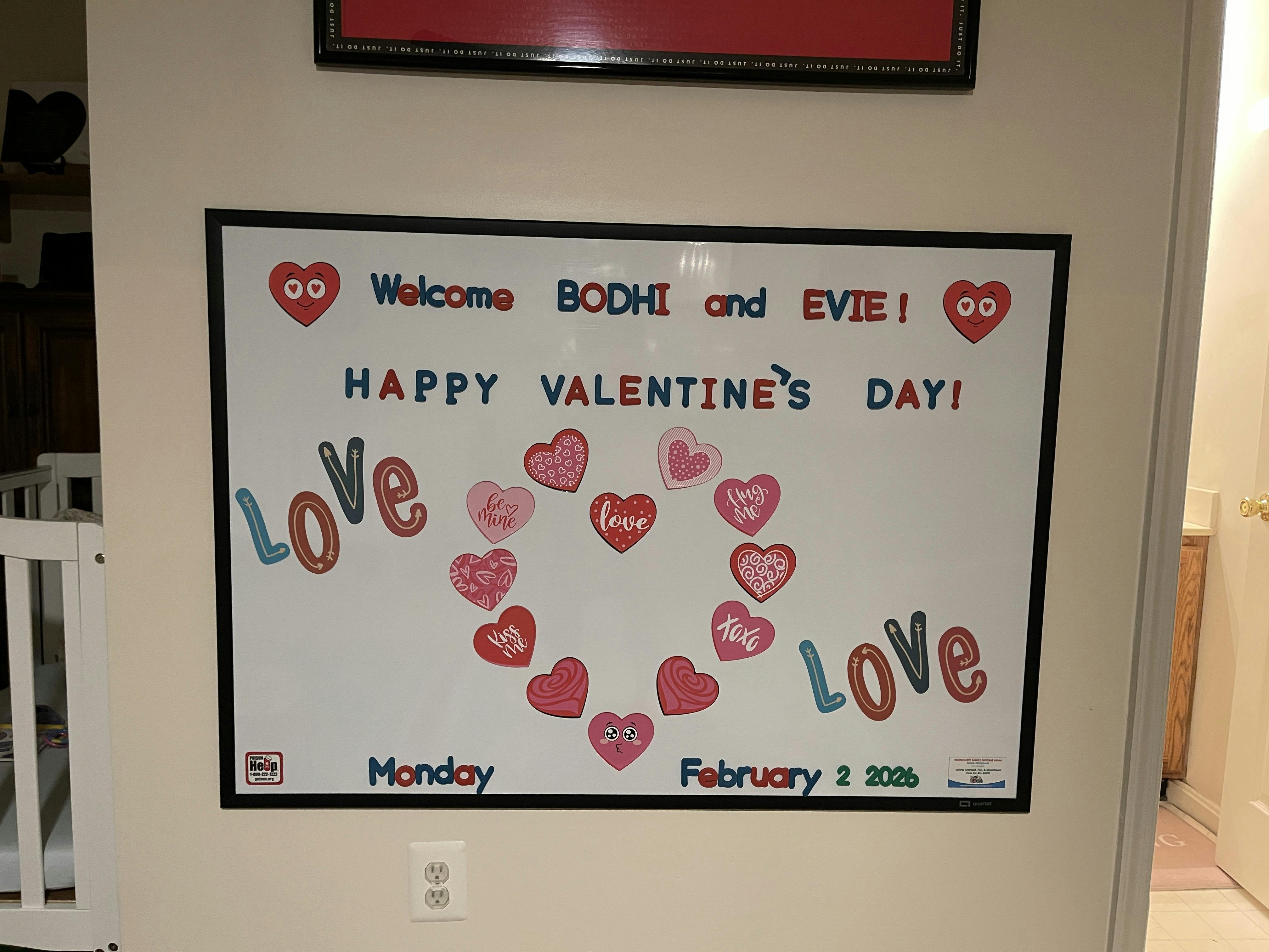 Whiteboard with "Welcome BODHI and EVIE! HAPPY VALENTINE'S DAY!" and hearts